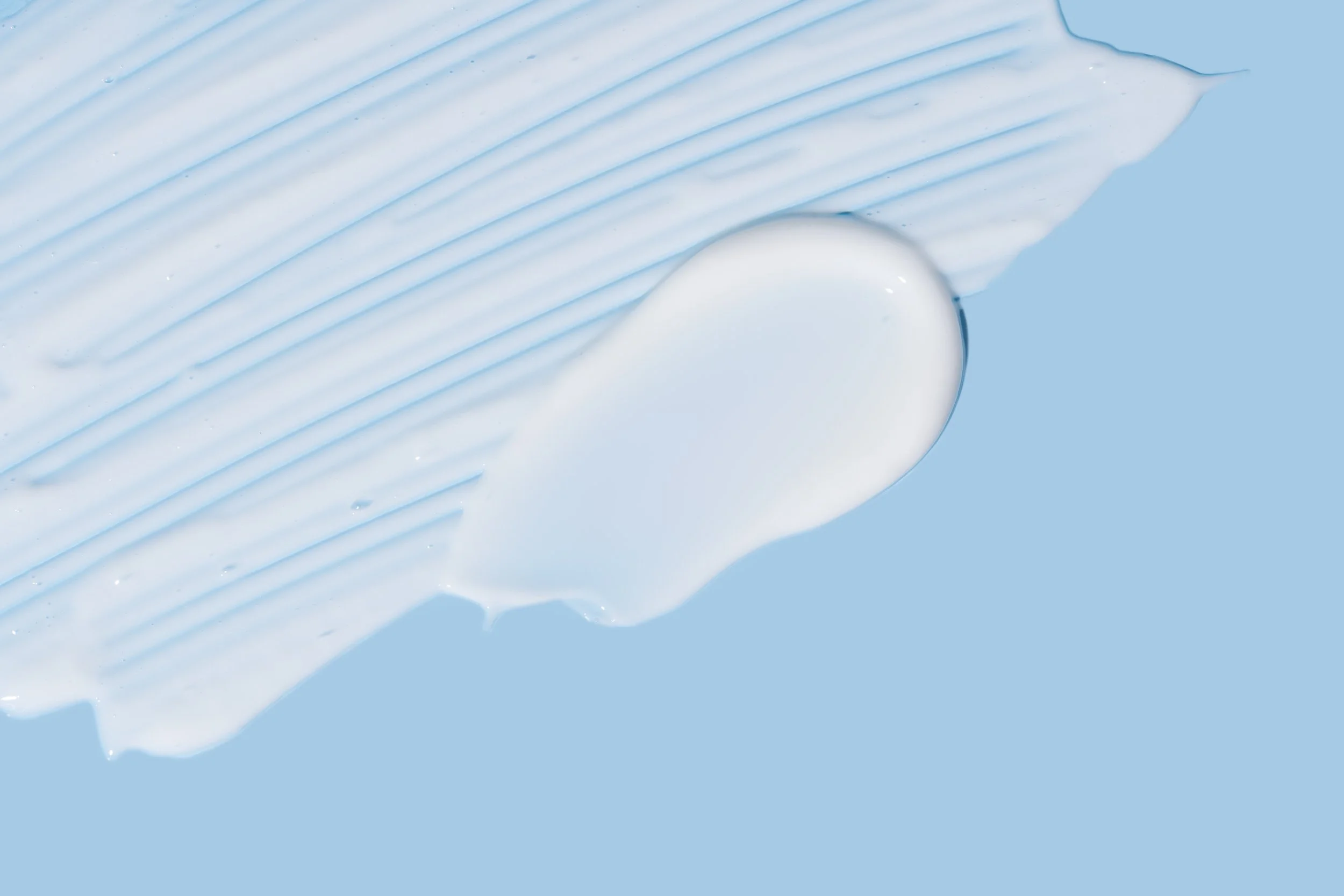swirls-of-creamy-lotion-on-a-light-blue-background-2026-03-26-23-35-13-utc.jpg