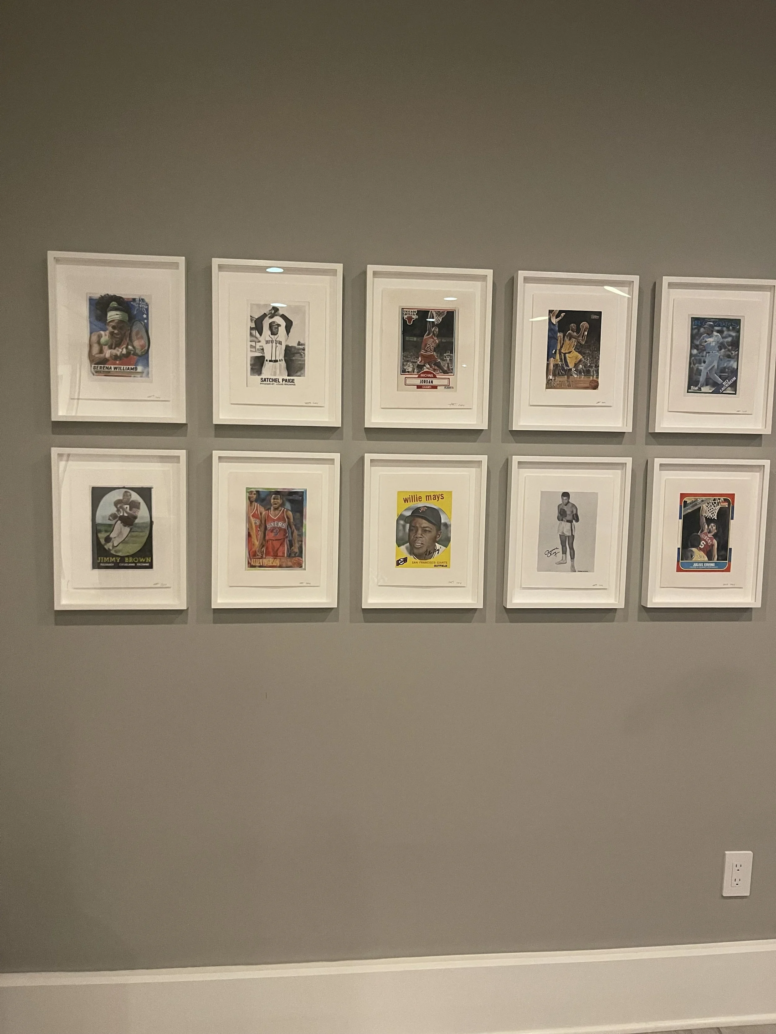 A wall with framed basketball trading cards arranged in a grid pattern, featuring various players.