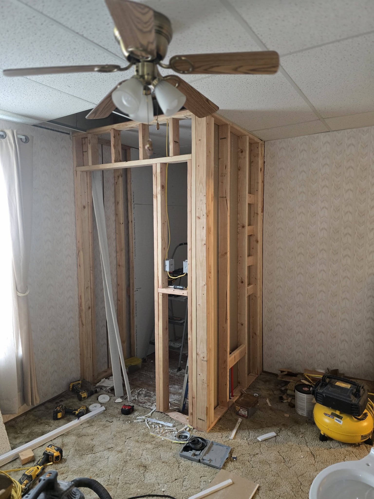 New stud walls framed for the half bath, with tools on site