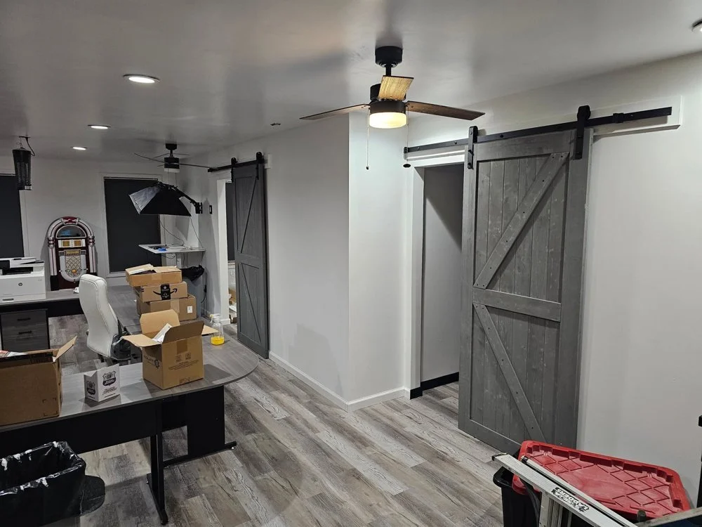 Converted room with new floor and barn-style door