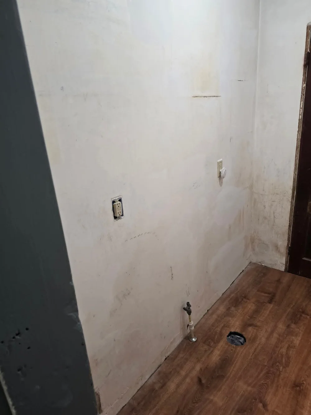 New floor in place, old plumbing stripped away.