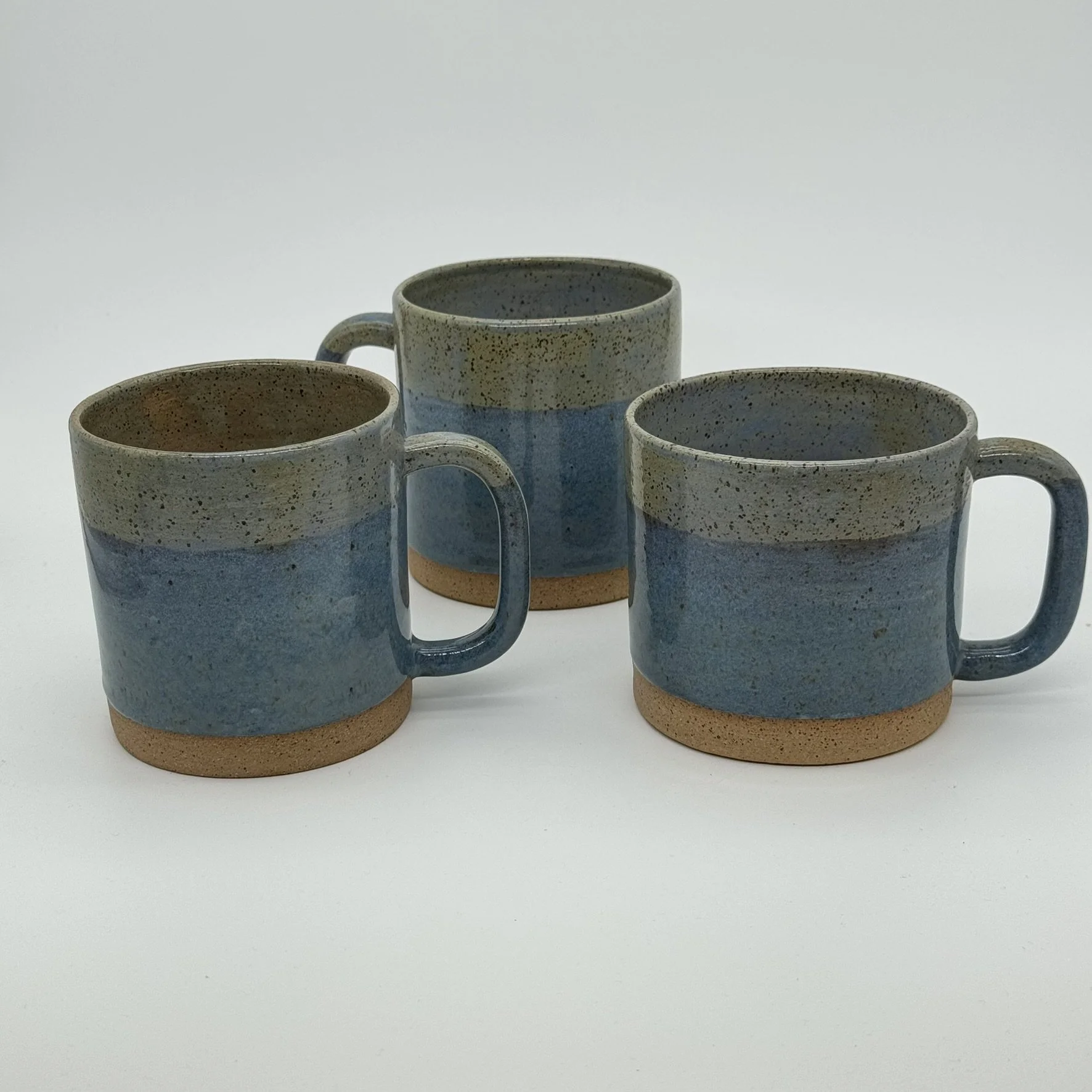 3 layer blue glaze cylinder mugs speckled brown clay 3.JPEG