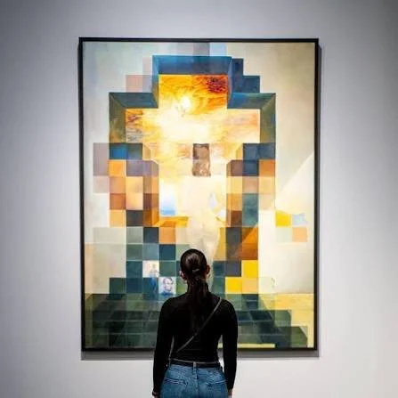 Person standing and observing a pixelated digital artwork of Abraham Lincoln's face with vibrant colors and abstract design.