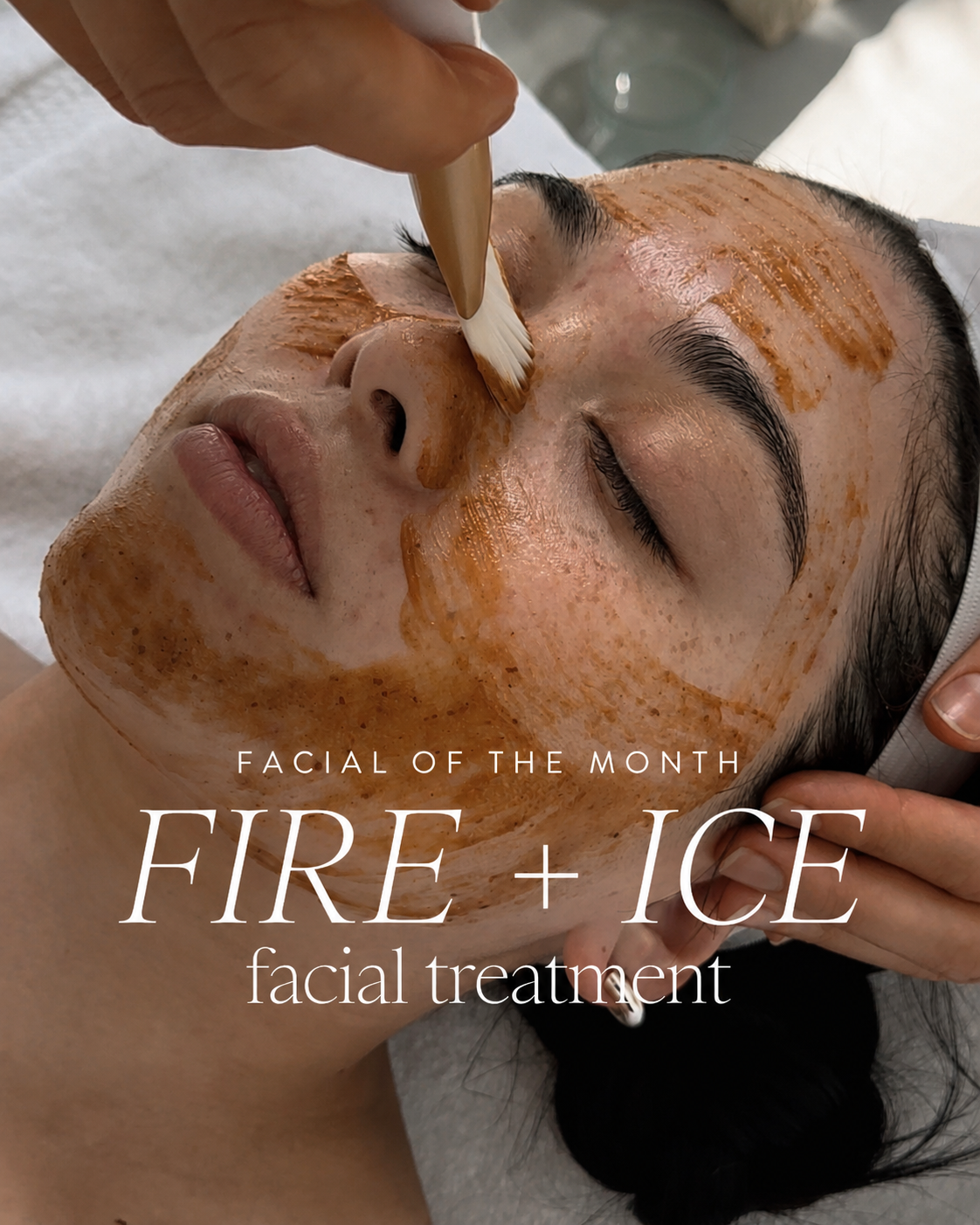 A woman receiving a facial treatment with a mask being applied to her face by an esthetician, with text overlay: 'Facial of the Month Fire + Ice Facial Treatment'.