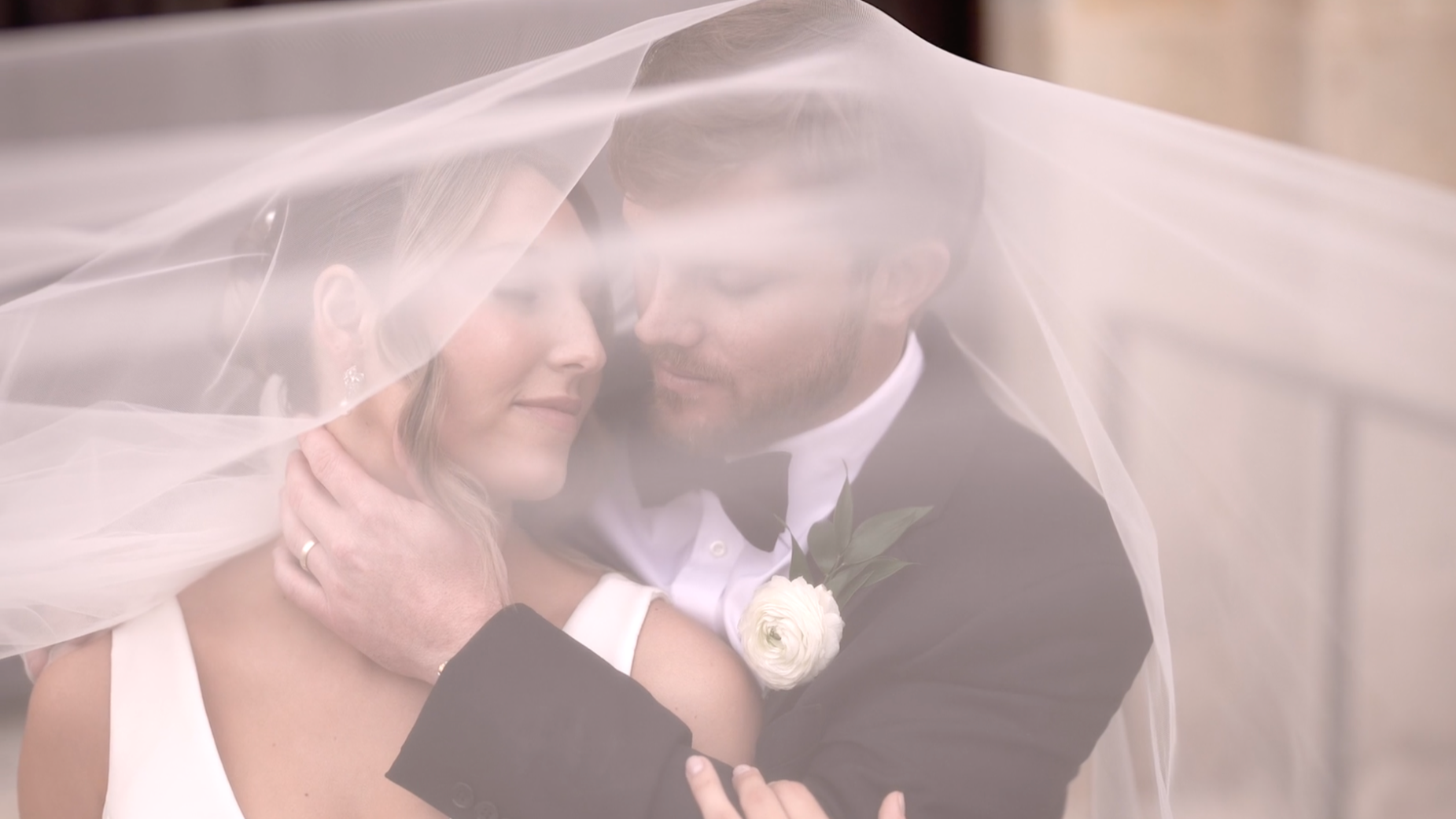 Bride and groom in an intimate moment under the veil at sunset.      