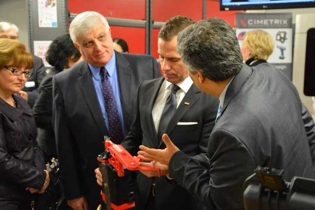 Tom Murad, Ph.D., P.Eng., in collaboration with other attendees and display booths at a conference for student education, innovation and program development.