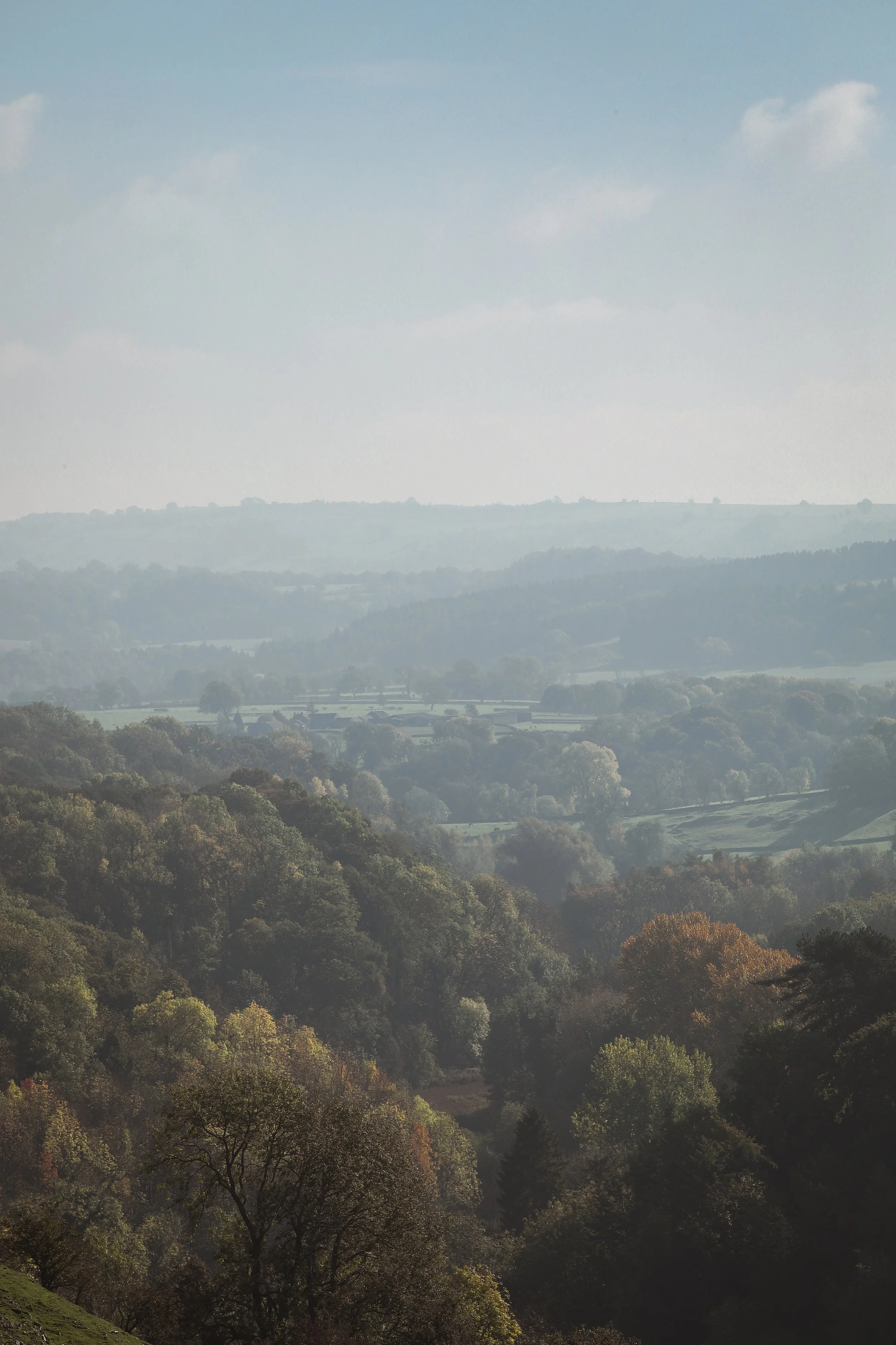 Wooded hills and valley viewed across the countryside. The beautiful early autumn scene at Over Haddon in the Peak District when Arundo5 arrived in the morning for before their concert