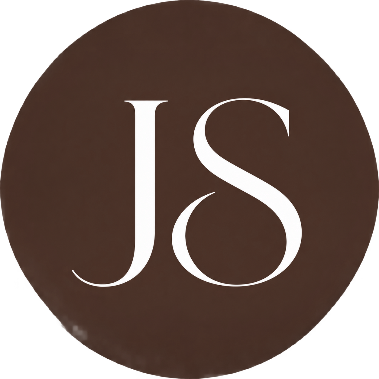 Close-up of a round dark brown surface with large white initials 'J S' in the center.