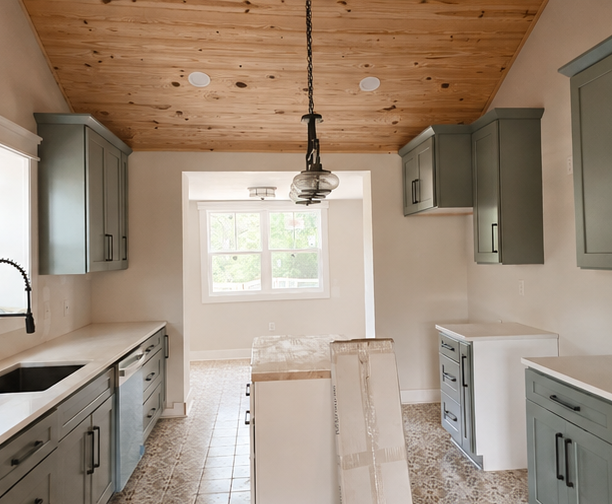 Kitchen with green cabinets, a wooden ceiling, a window, and an island in the center.