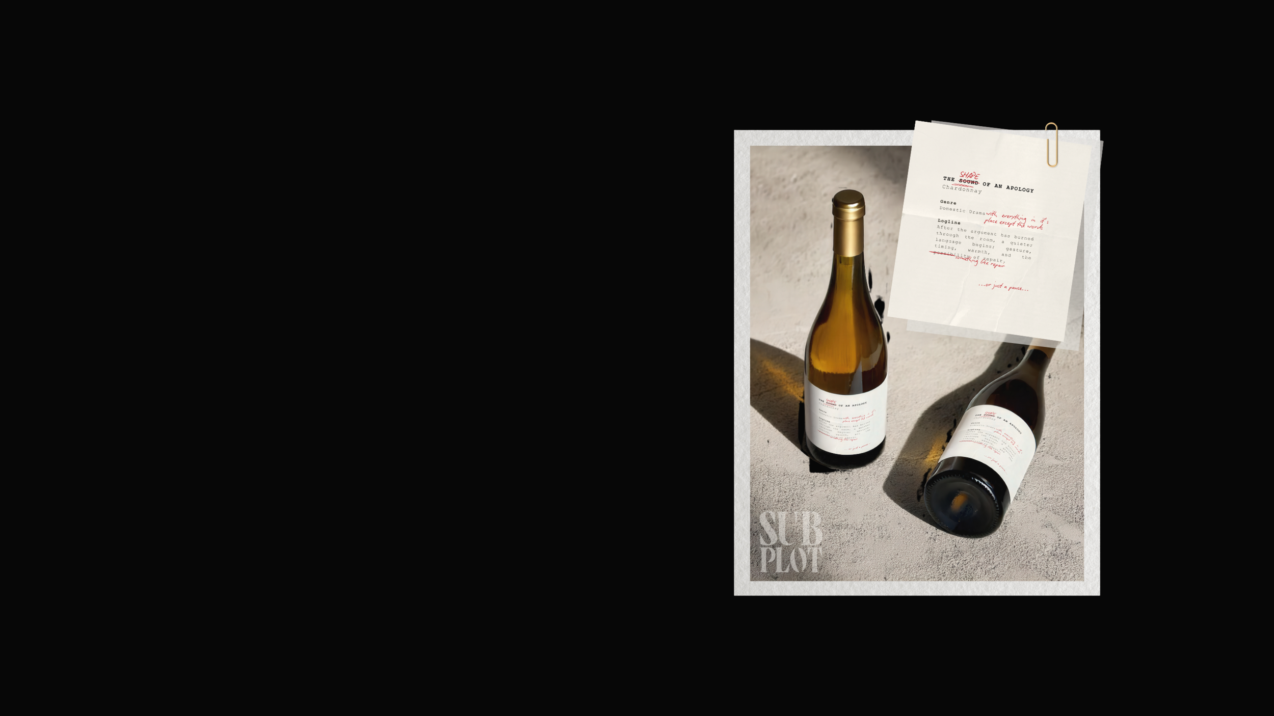Two wine bottles placed on sand next to a polaroid-style photo with handwritten notes and a paperclip, with text 'SUB PLOT' at the bottom.