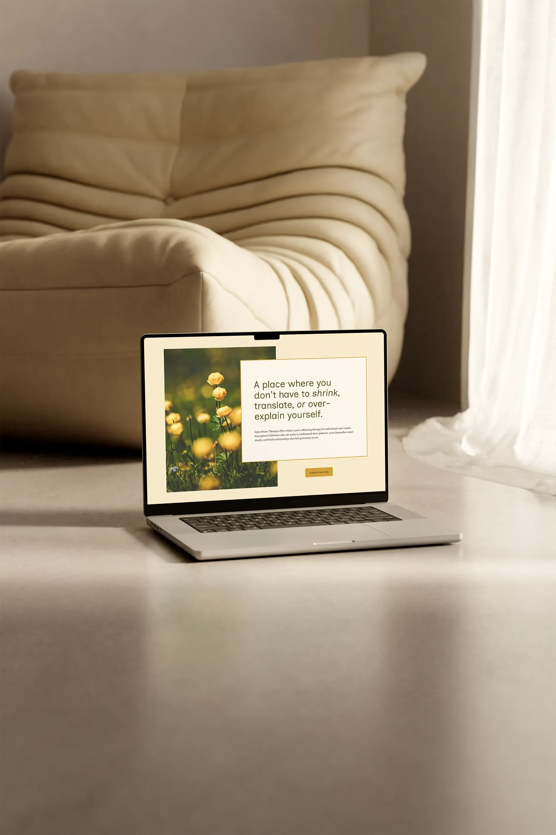 Laptop on a table displaying a webpage with a floral background and a quote about not having to shrink, translate, or over-explain oneself.