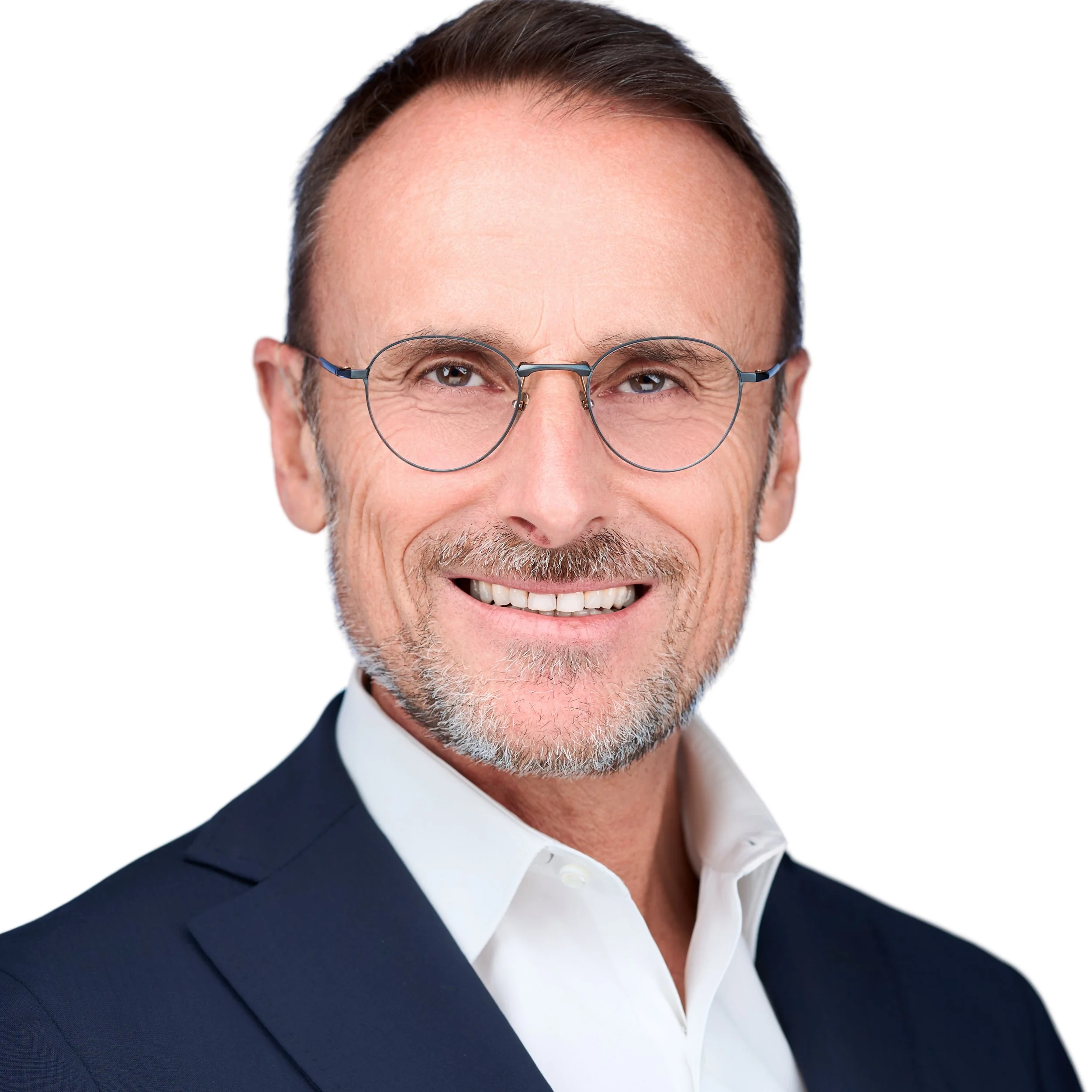 DAVIDSAGGIO Photography Tampa male executive headshot. Wearing glasses, white open collar shirt and dark blue jacket.