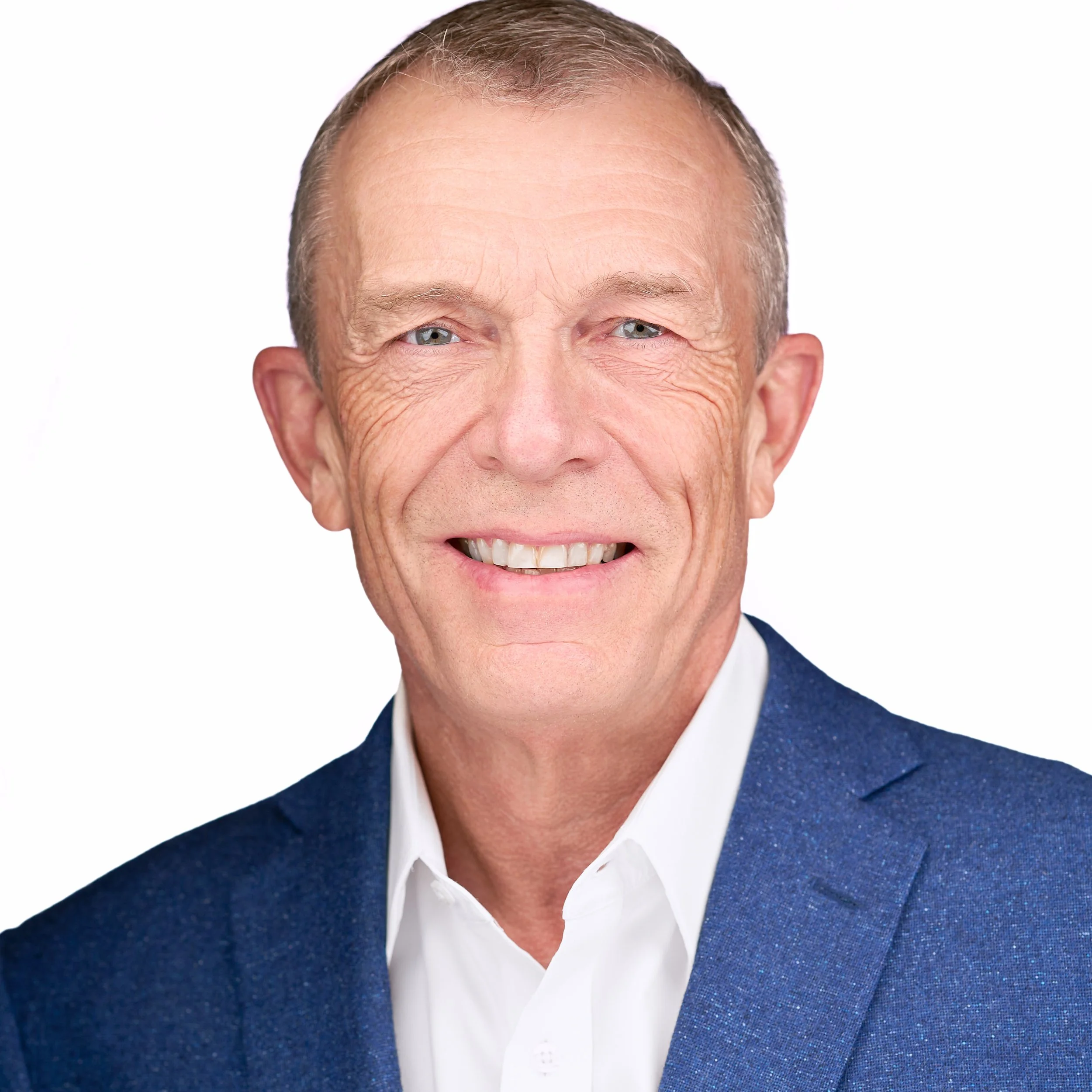 DAVIDSAGGIO Photography Tampa male executive headshot. Welcoming smile and eyes. Wearing a white button down with medium blue jacket against a white background.