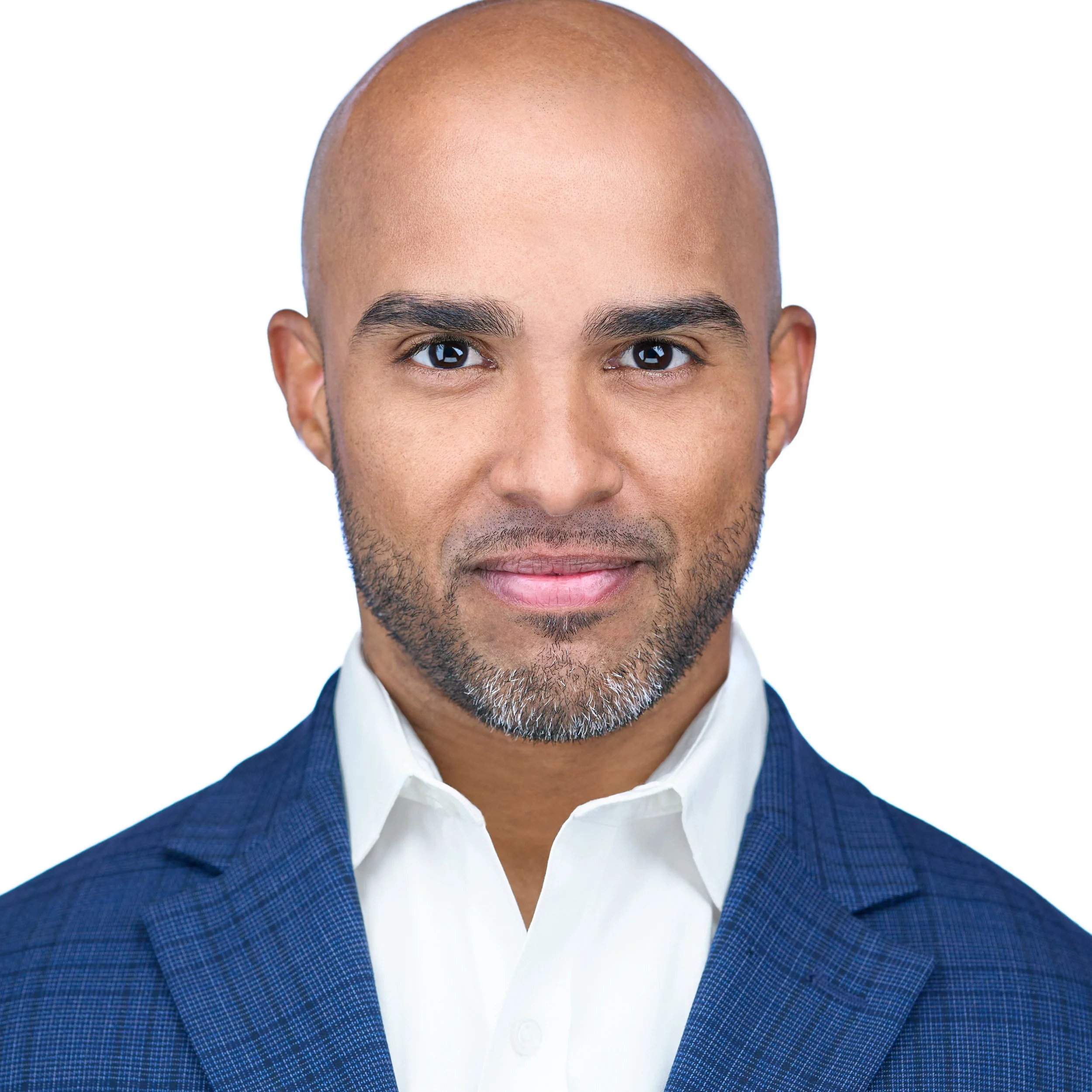 DAVIDSAGGIO Photography Tampa executive headshot. Light complexion black male with tightly cropped beard and intense, but welcoming eyes. Wearing white button down, medium blue jacket against a white background.