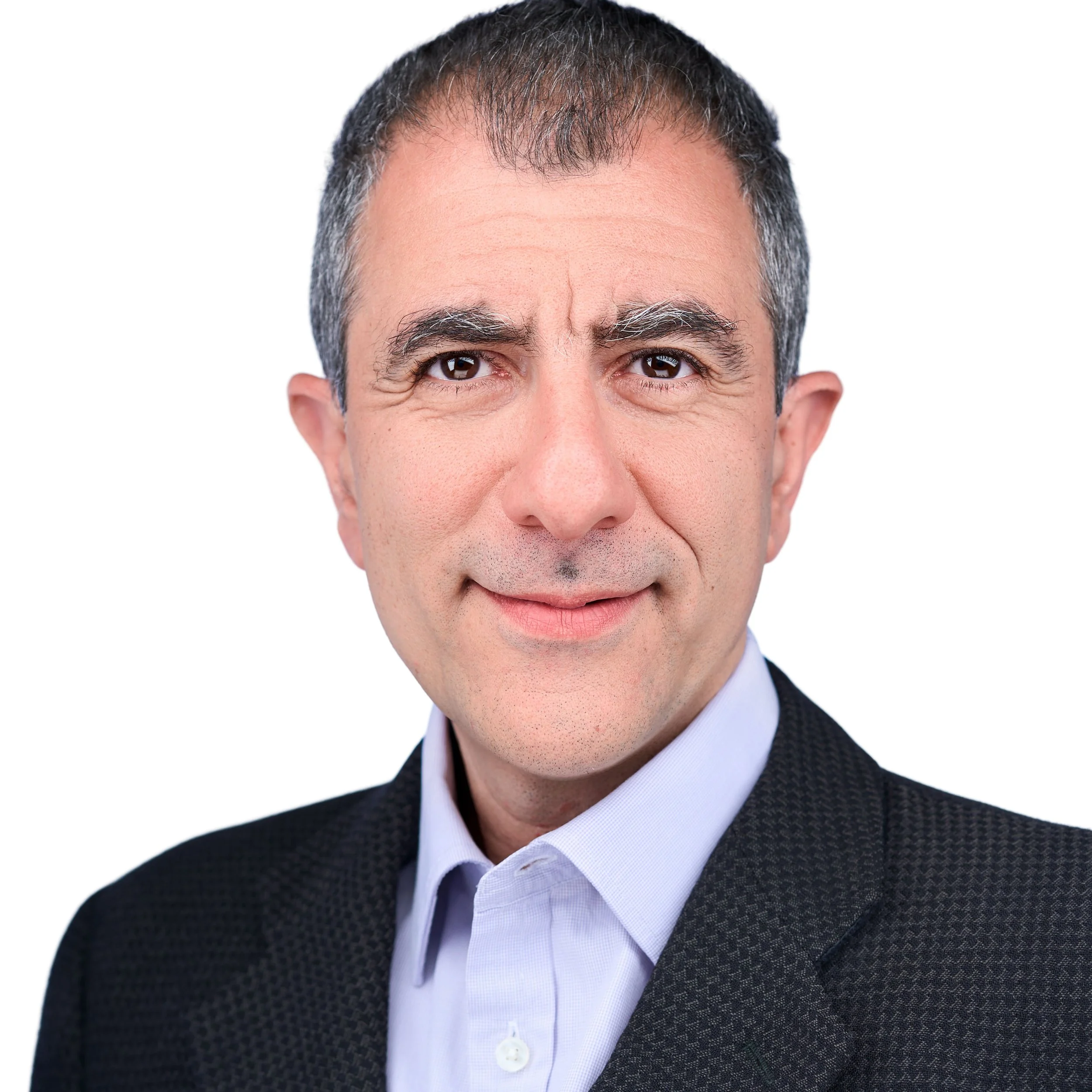 DAVIDSAGGIO Photography Tampa male pharma executive headshot. Confident look wearing light blue button down with gray jacket against white background.