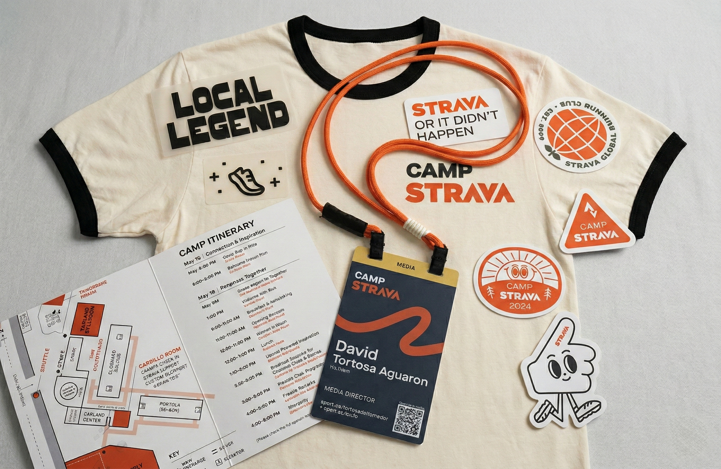 T-shirt with various stickers and badges related to Strava and a schedule for a camp. Include stickers with phrases like 'Local Legend' and 'Strava or it didn't happen,' along with a character sticker and a lanyard with a name tag.