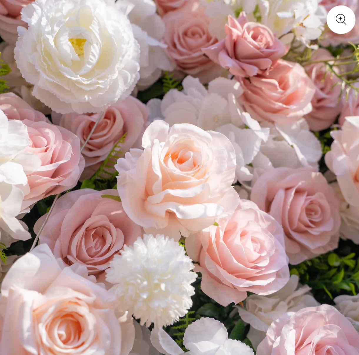 Close-up of pink and white roses and white carnations in a floral arrangement.
