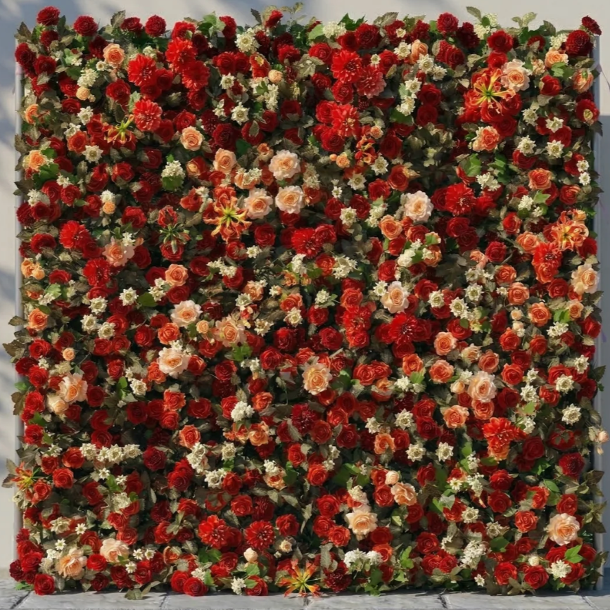 A wall decorated with numerous red and peach-colored roses, white small flowers, and green foliage.