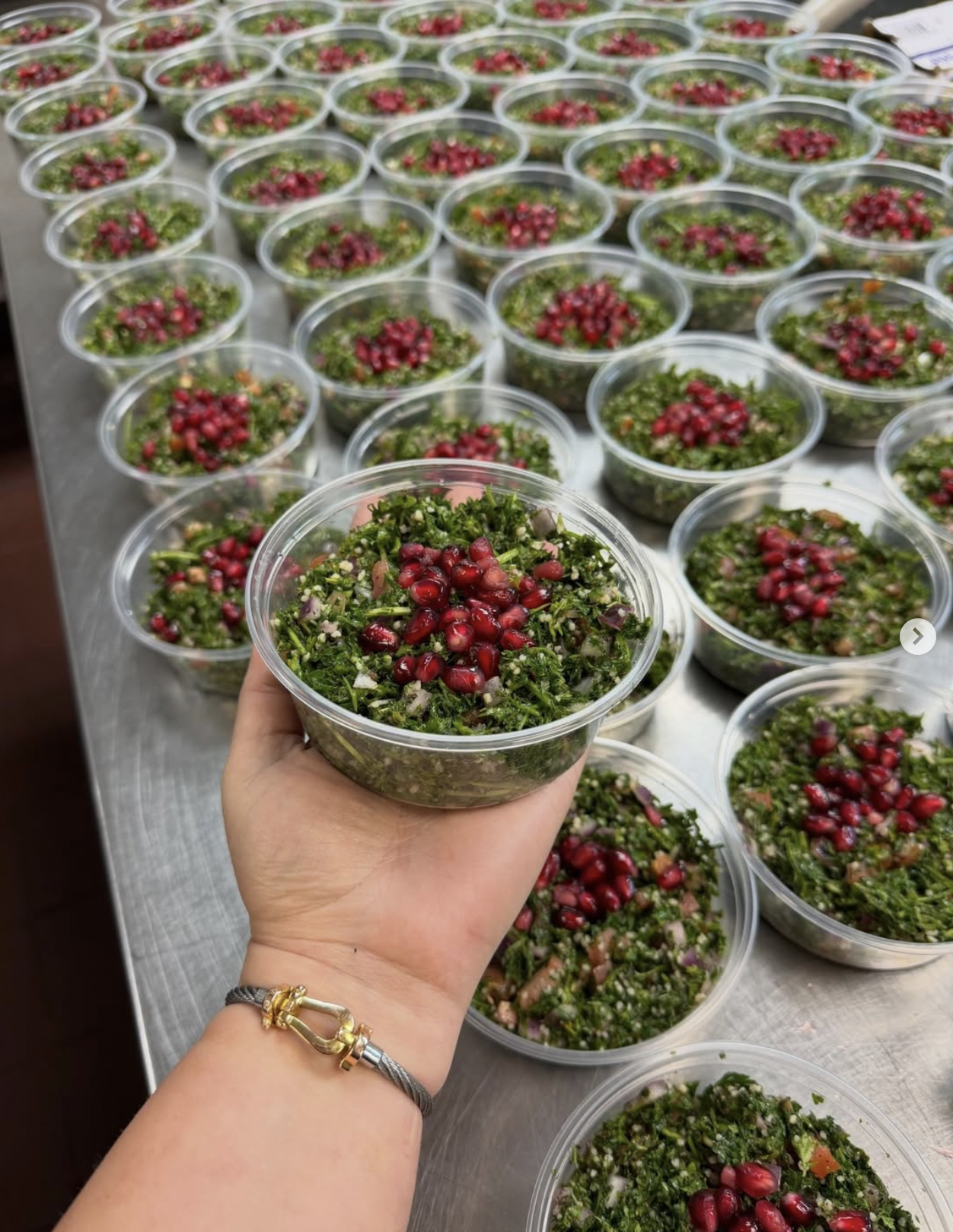 Fresh Yalla Dips tabbouleh topped with pomegranate seeds, prepared in Madison, Wisconsin.