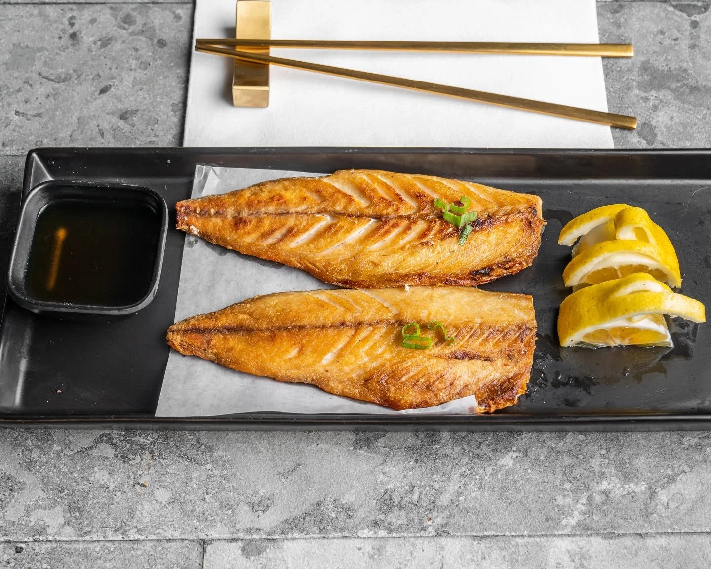 Grilled mackerel with green onions and lemon at The Crew Korean Restaurant in San Francisco’s Sunset District.