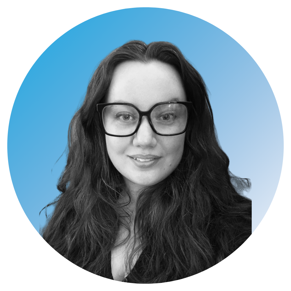 A woman with long dark hair, wearing glasses with a black frame, smiling slightly, against a blue gradient background with circular design.