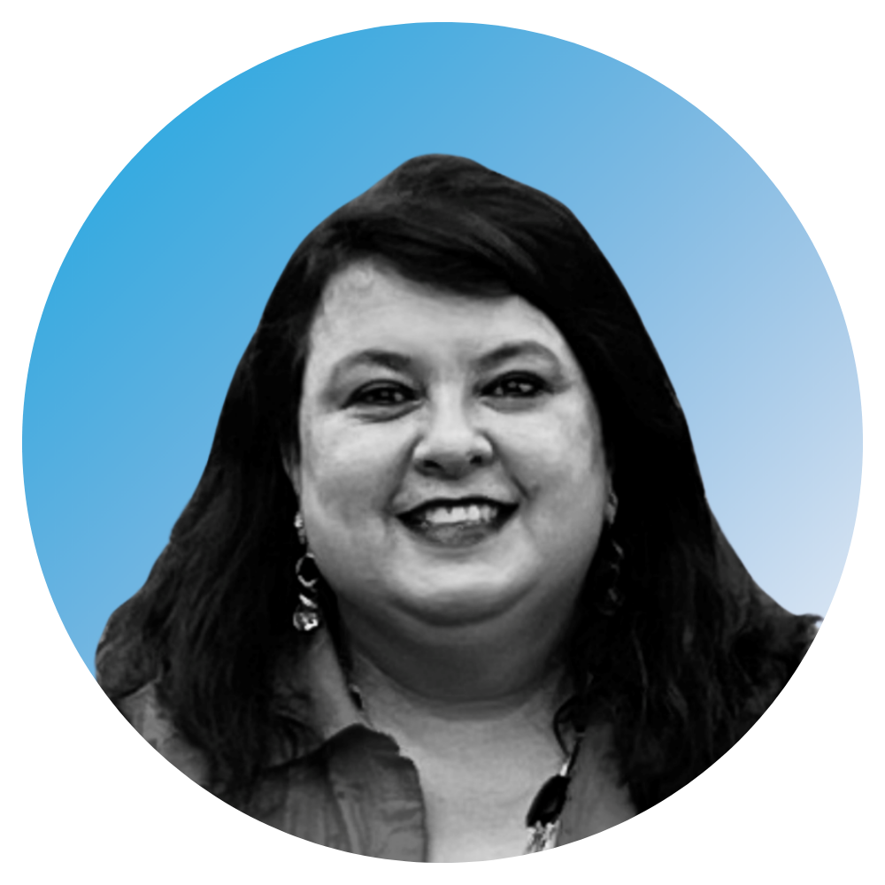 Black and white headshot of a smiling woman with shoulder-length dark hair, earrings, and a collared shirt, set against a blue background with a circular cutout.