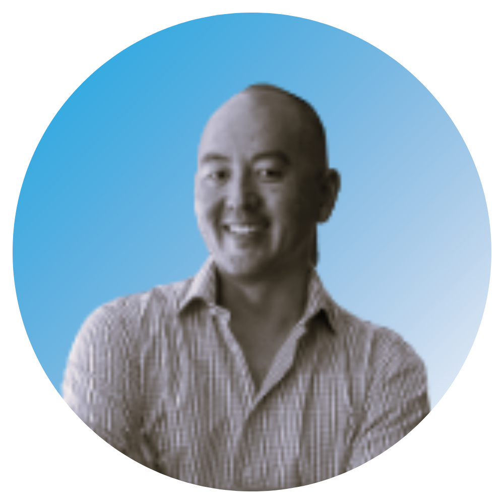 Portrait of a smiling man with short hair, wearing a light-colored checkered shirt, against a blue background.