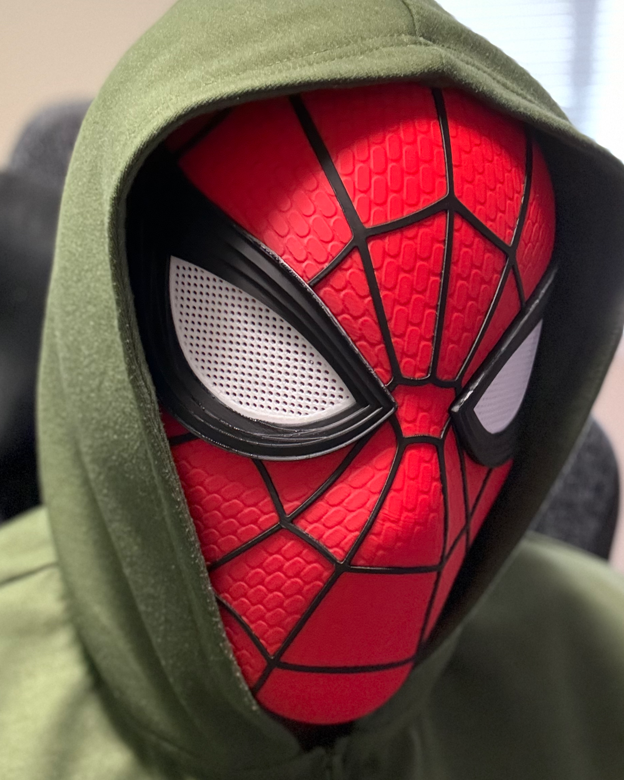 Spider-Man mask being worn with the removable eye pieces installed, showing the finished fit and appearance
