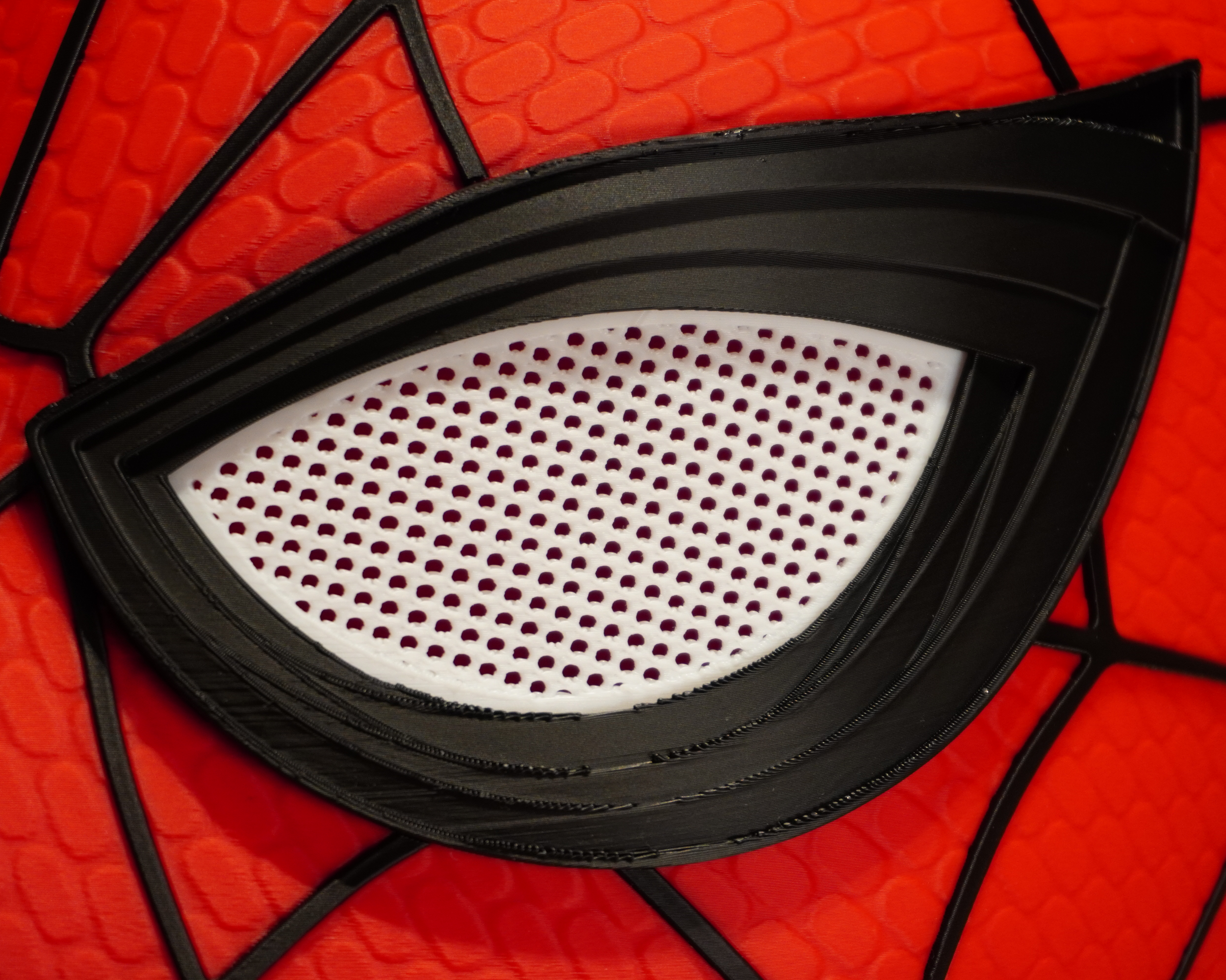 Close-up of the Spider-Man mask eye piece showing the mesh insert and printed surface details