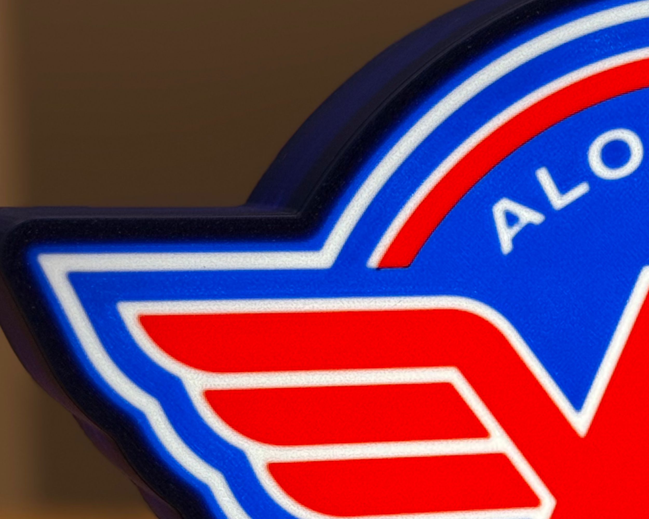 Close-up of the illuminated Alouettes Flightdeck Podcast lightbox showing the layered face details and 3D-printed surface texture