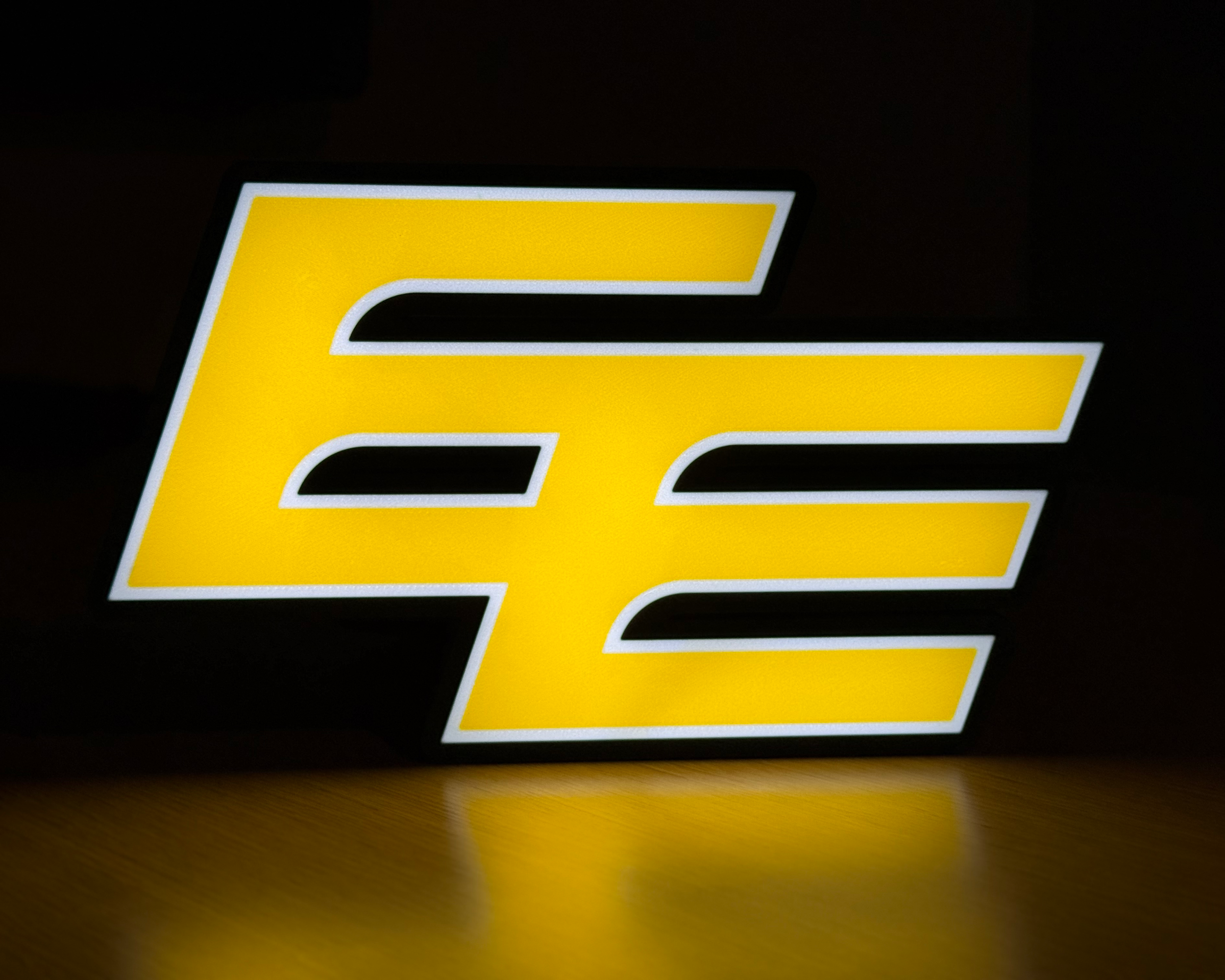 Illuminated front view of the Edmonton Elks logo lightbox against a dark background