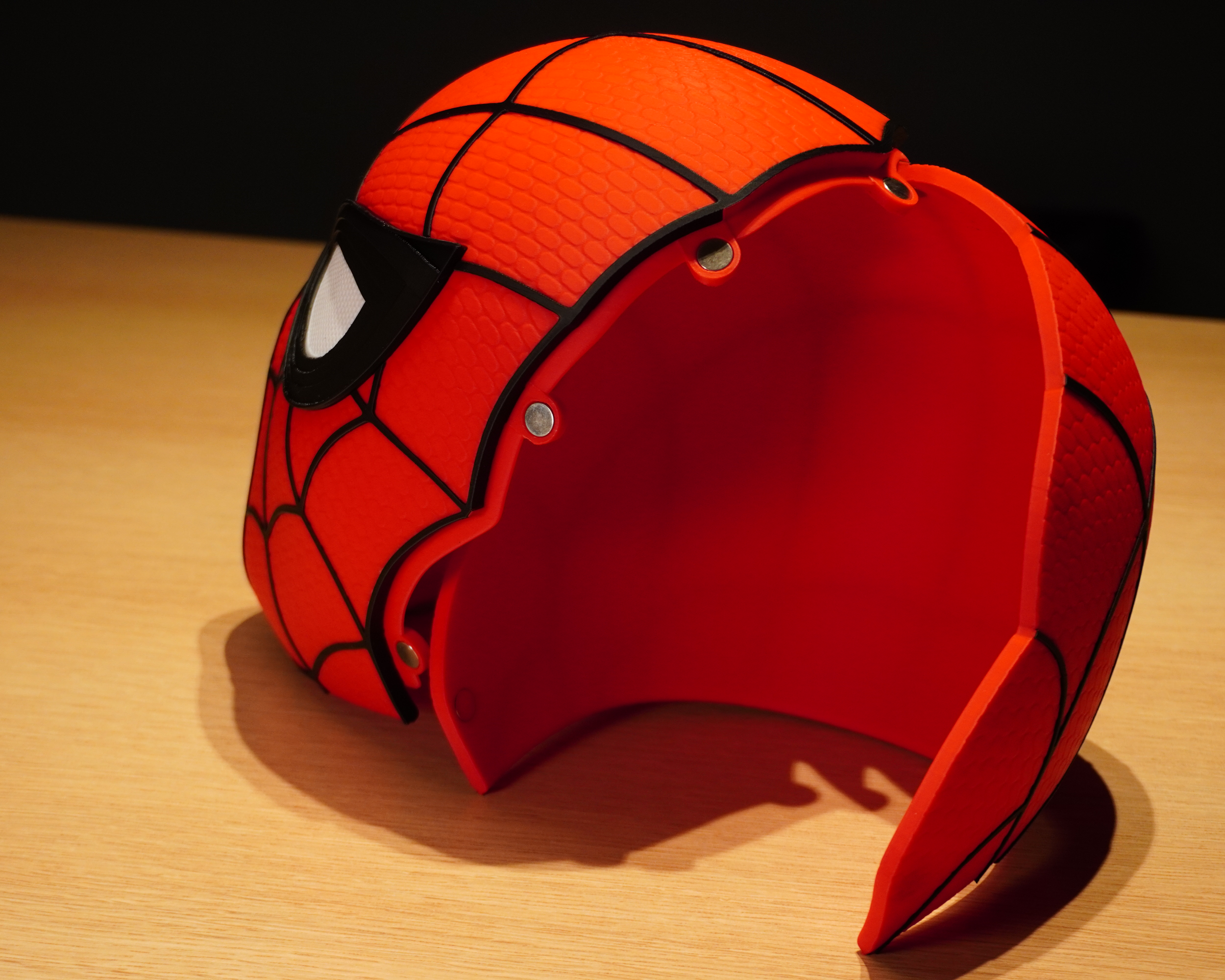 Spider-Man mask with the two-piece shell separated, showing the embedded magnets used to secure the sections together
