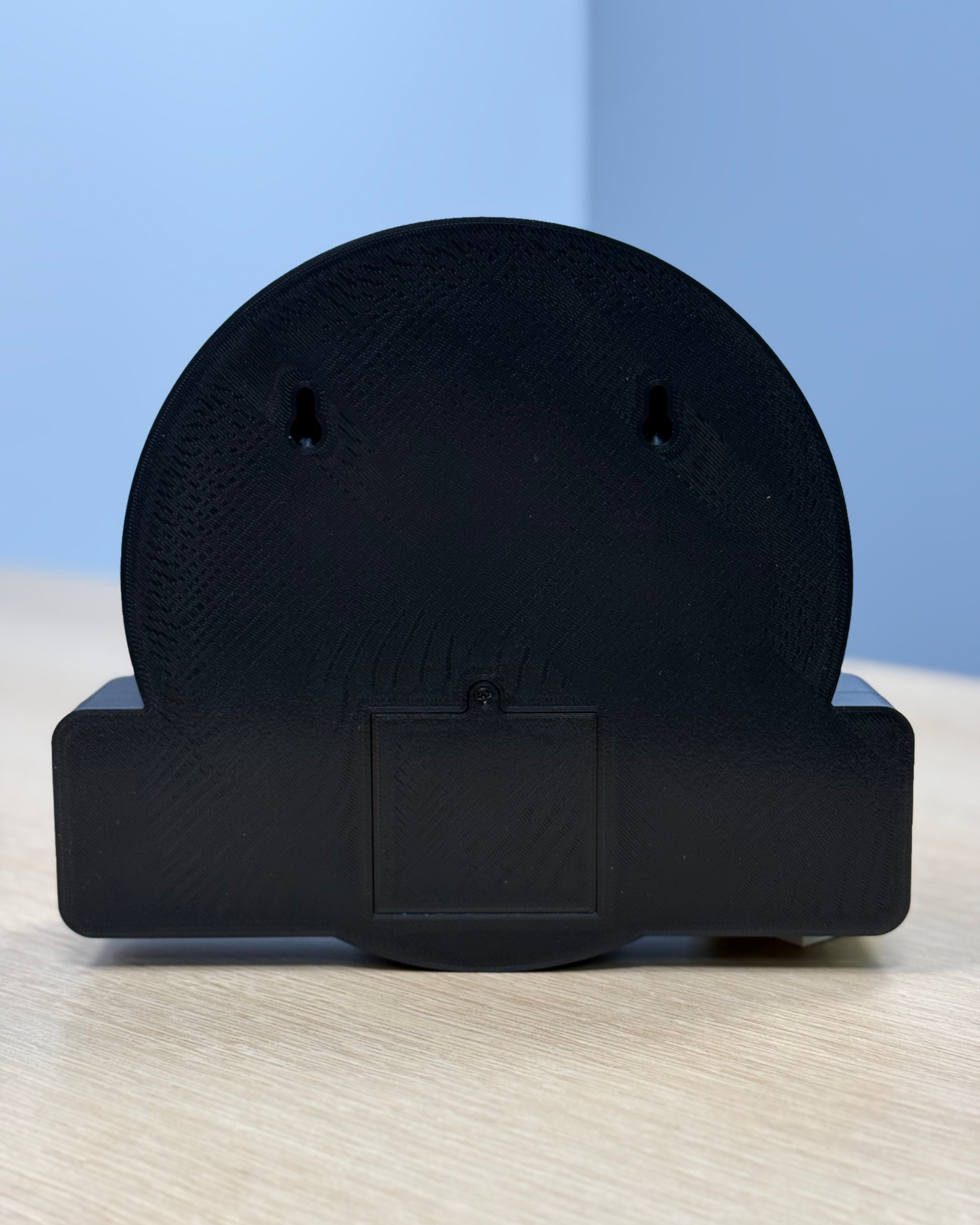 Rear view of the BC Lions Den Pawdcast lightbox showing the wall-mounting slots and rear battery compartment access panel