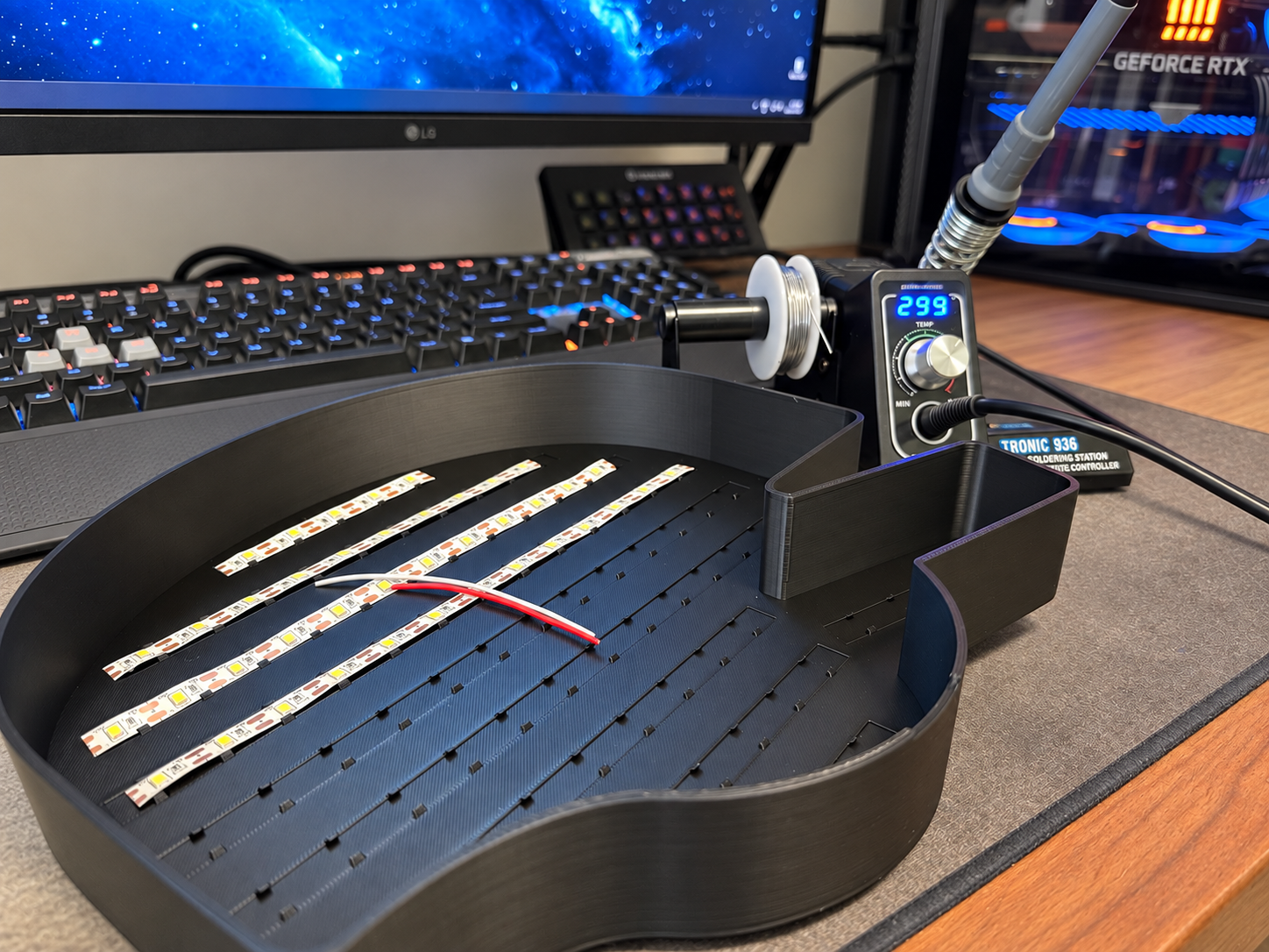 Custom 3D-printed lightbox housing with LED strips and assembly tools on a workbench