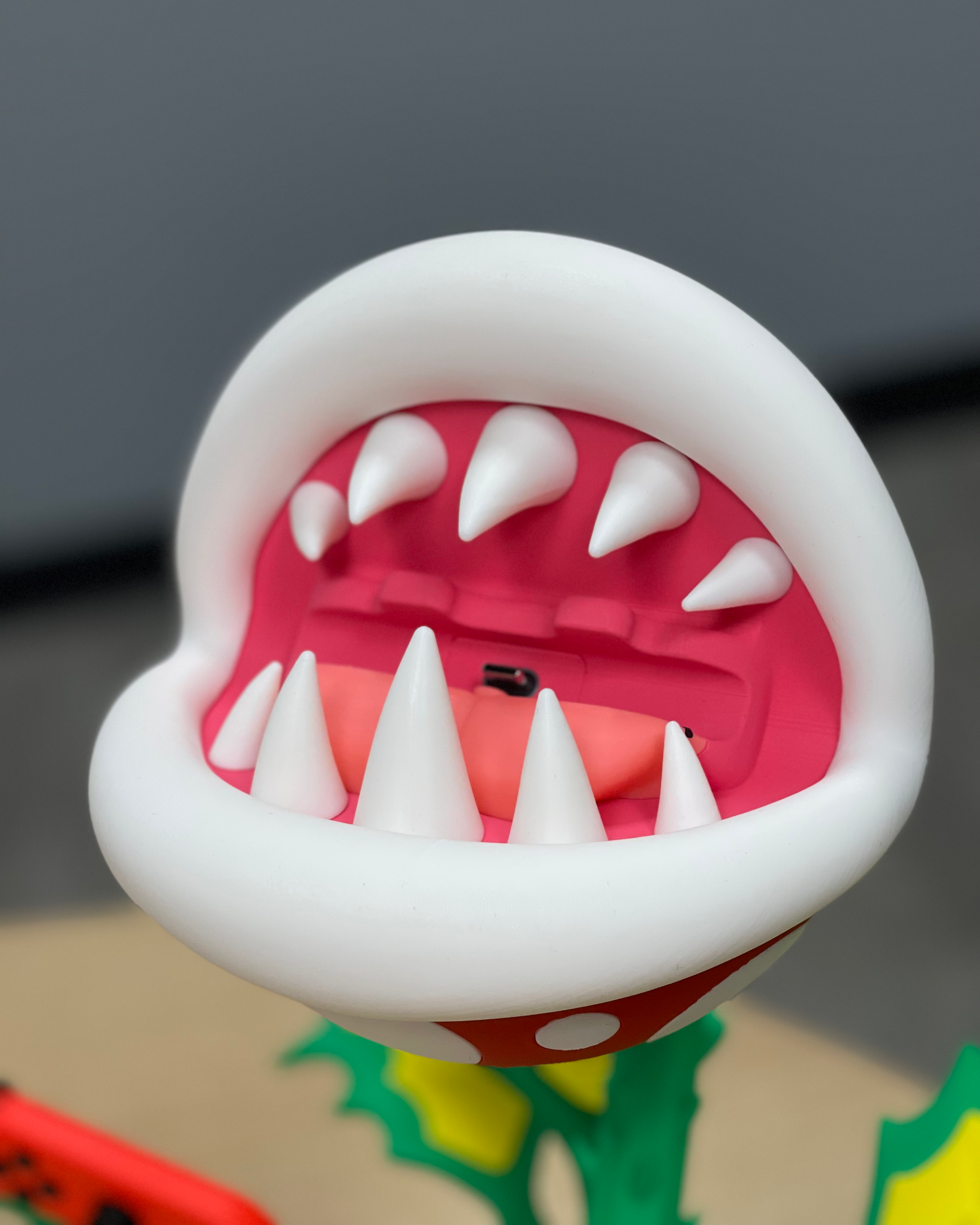 Close-up of the open Piranha Plant mouth showing the teeth and internal Nintendo Switch USB-C docking connection