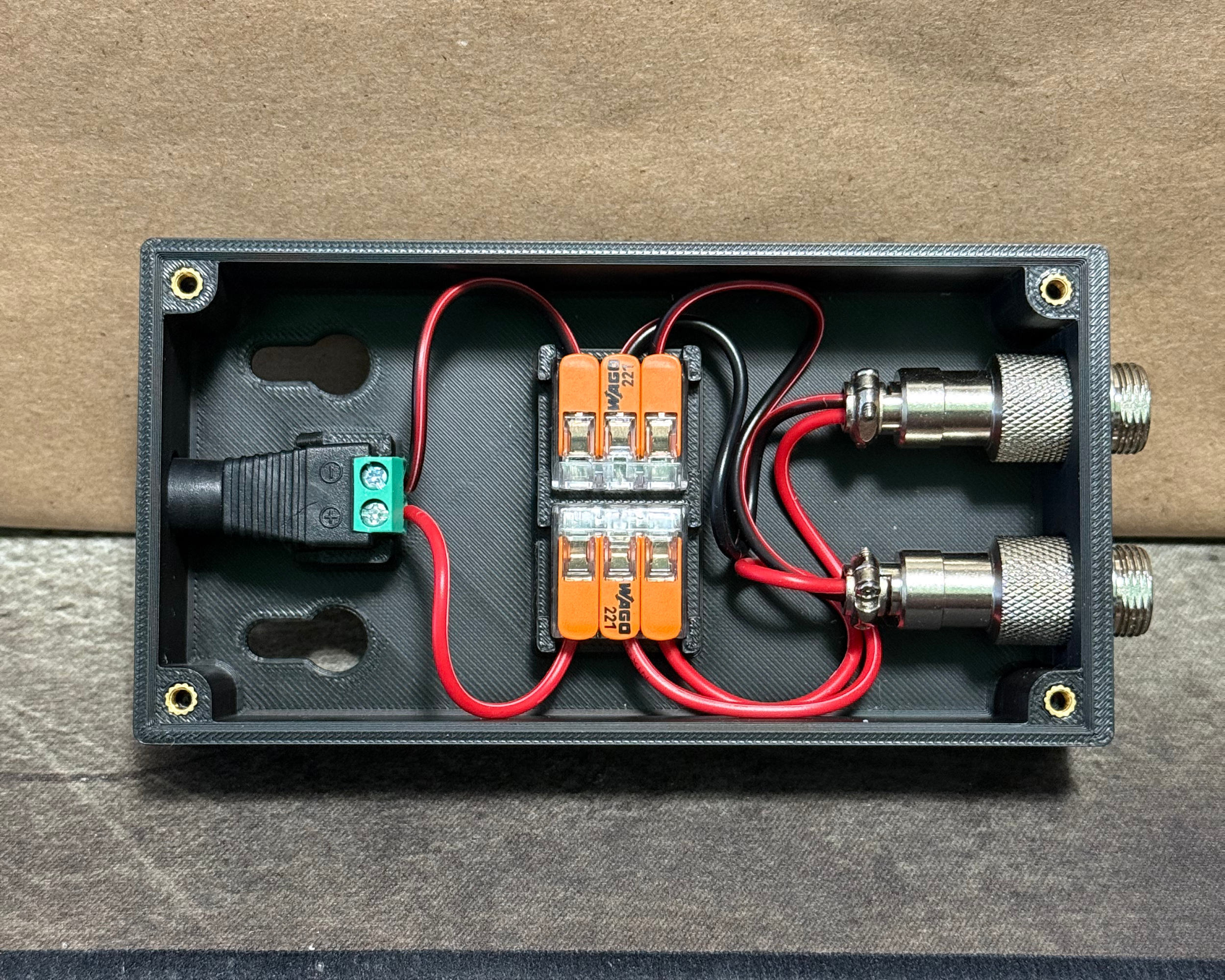 Top-down view of the main wiring enclosure showing the internal WAGO connectors, power input, wiring, and external connector ports