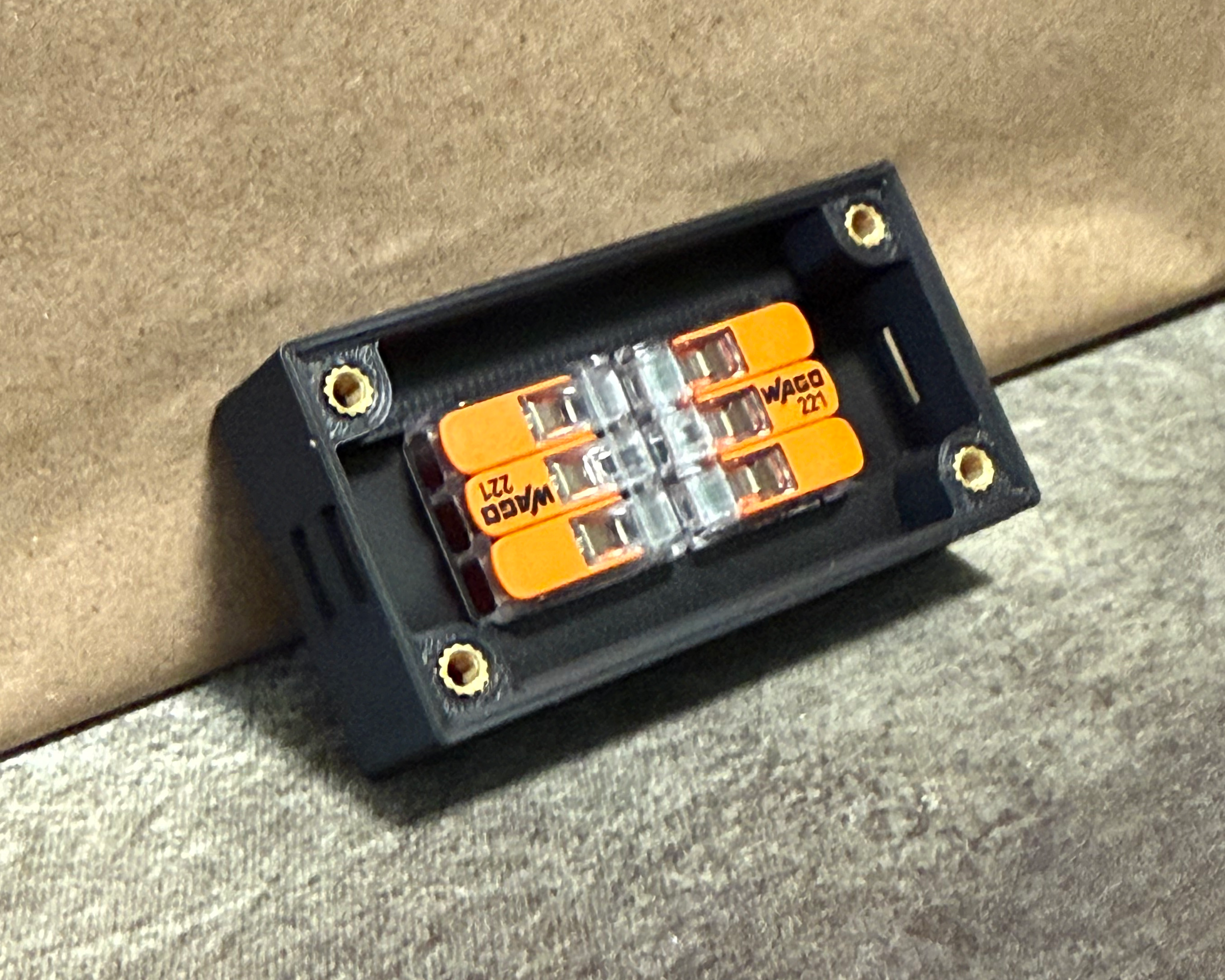Close-up of the smaller wiring enclosure showing the WAGO connectors and threaded insert mounting points