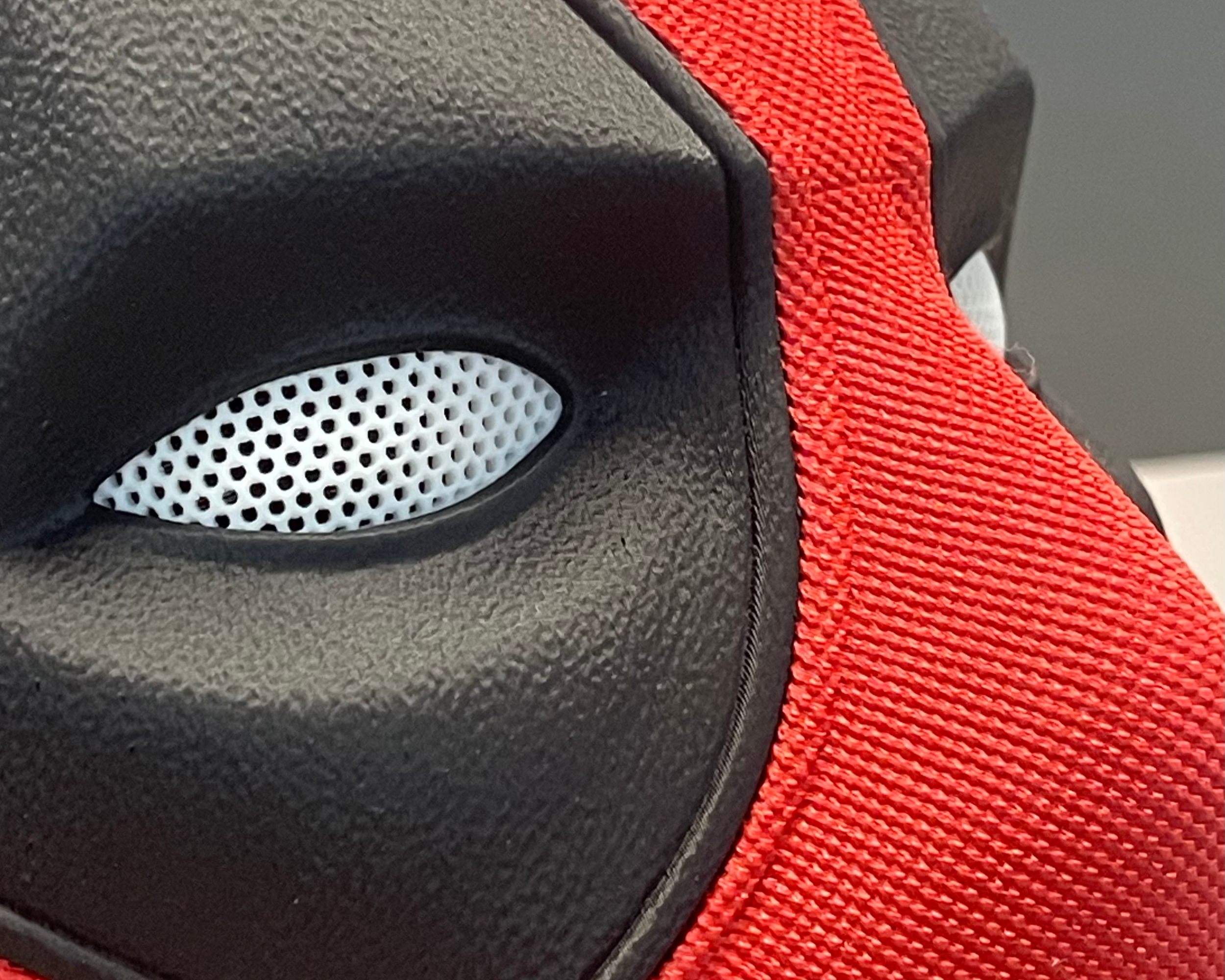 Close-up of the Deadpool mask eye assembly showing the white mesh insert and textured black surround