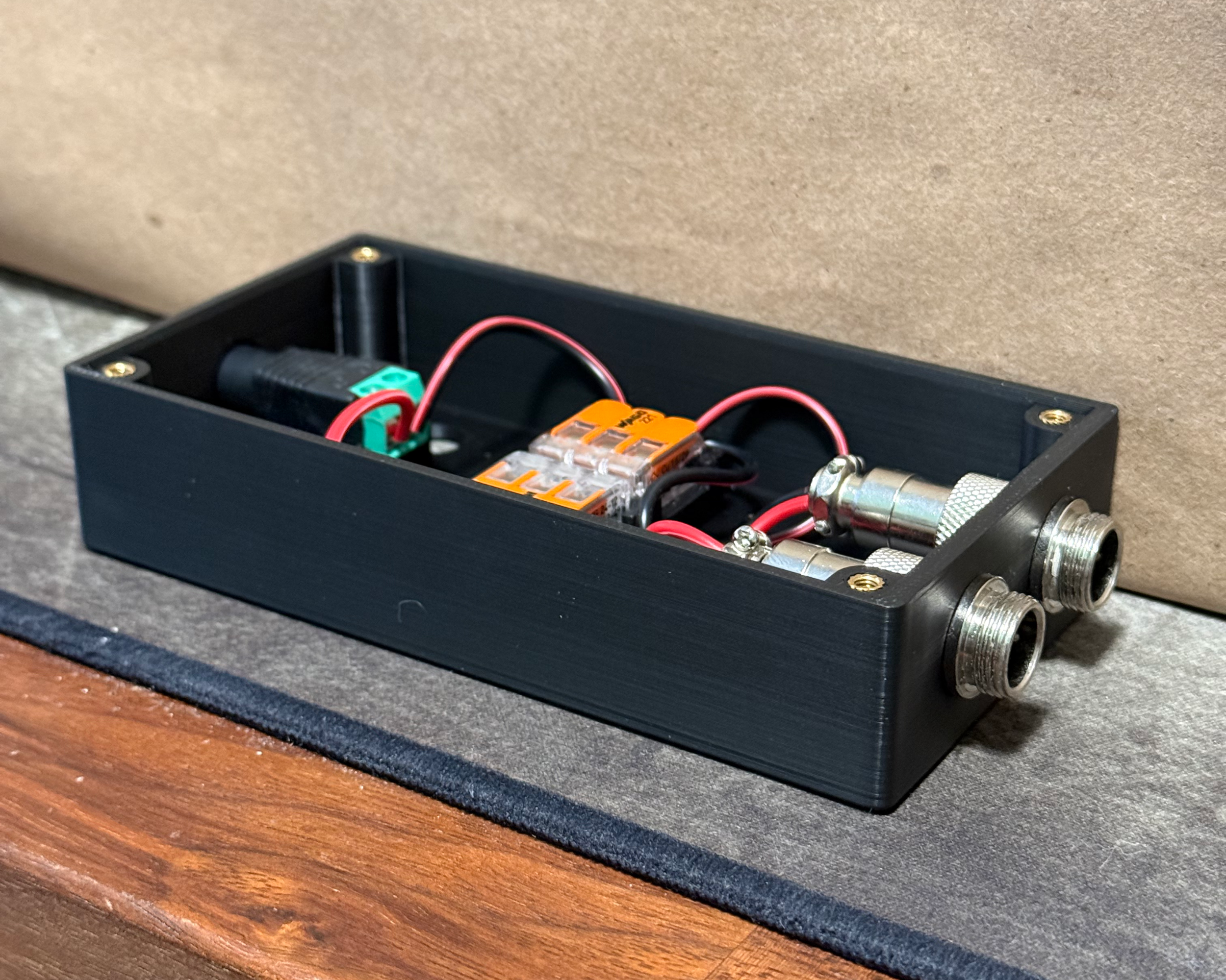Angled view of the main workbench lighting enclosure showing the housing depth, internal wiring, and two external connectors