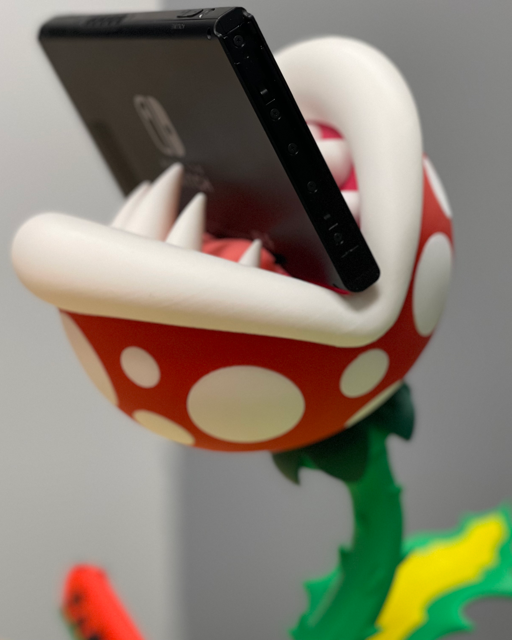 Close-up of the Piranha Plant’s head showing the Nintendo Switch docked between the upper and lower jaws