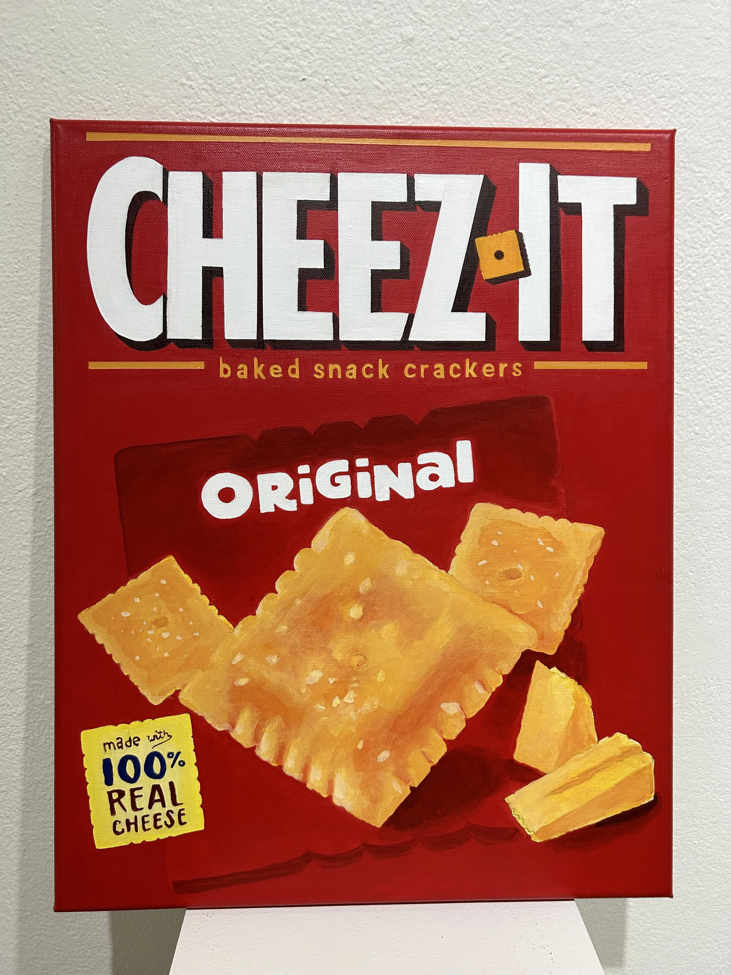 Red box of Cheez-It baked snack crackers showing cheese-flavored crackers with a yellow label indicating they are made with 100% real cheese.