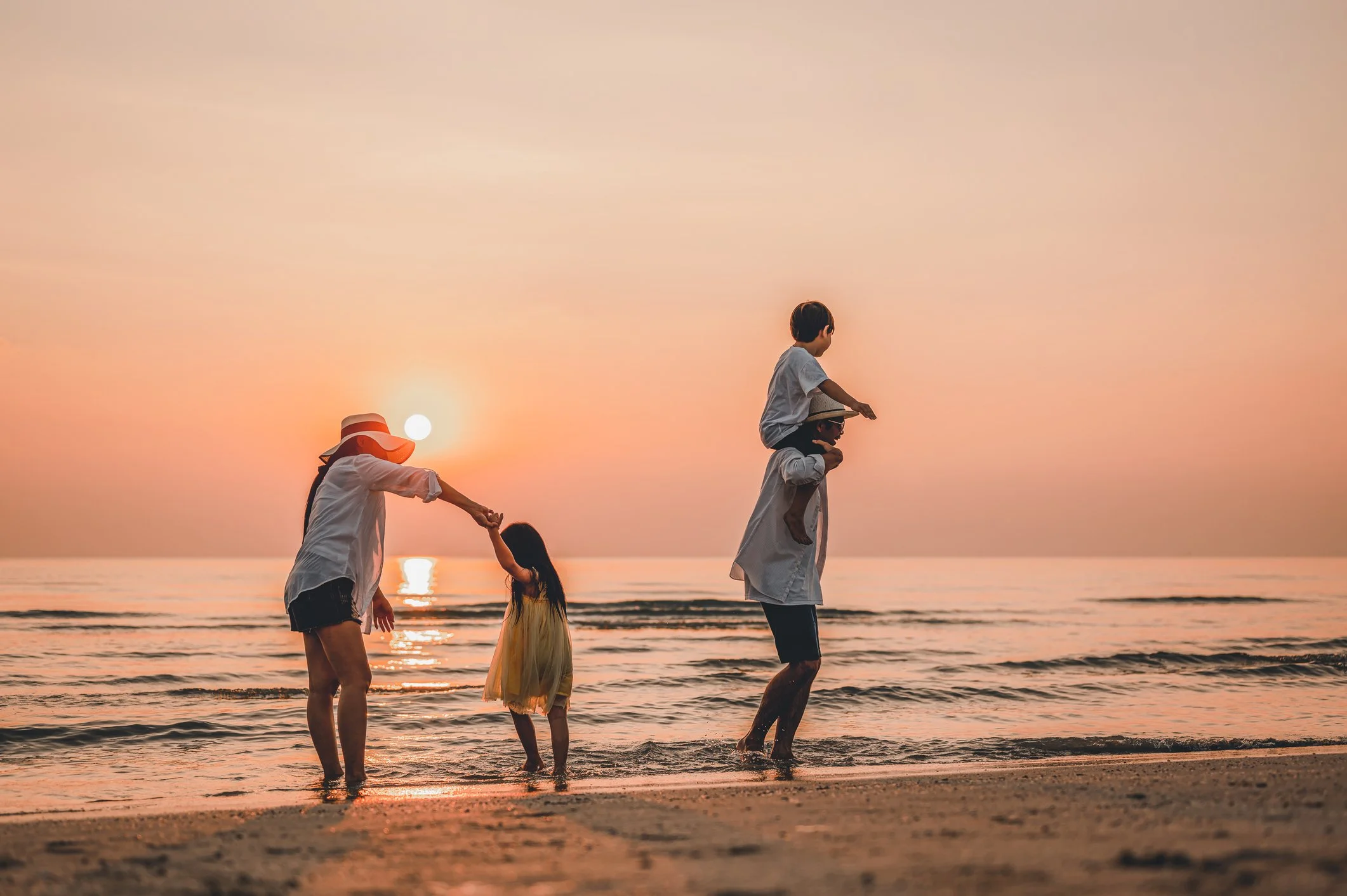 The Grandparent Village family playing on beach