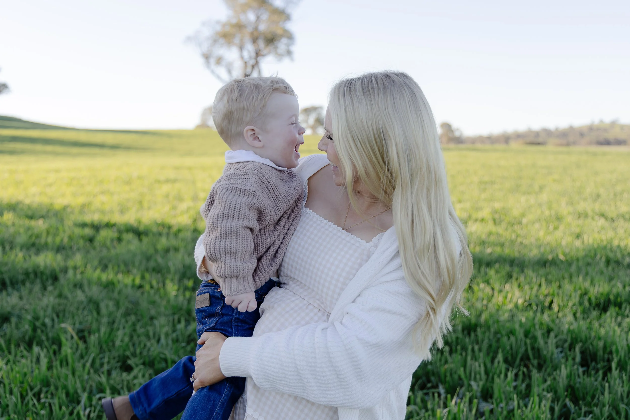Mum and son sharing a joyful, candid moment during a golden hour family photoshoot in Yass NSW, captured by Monique Patmore Photography.