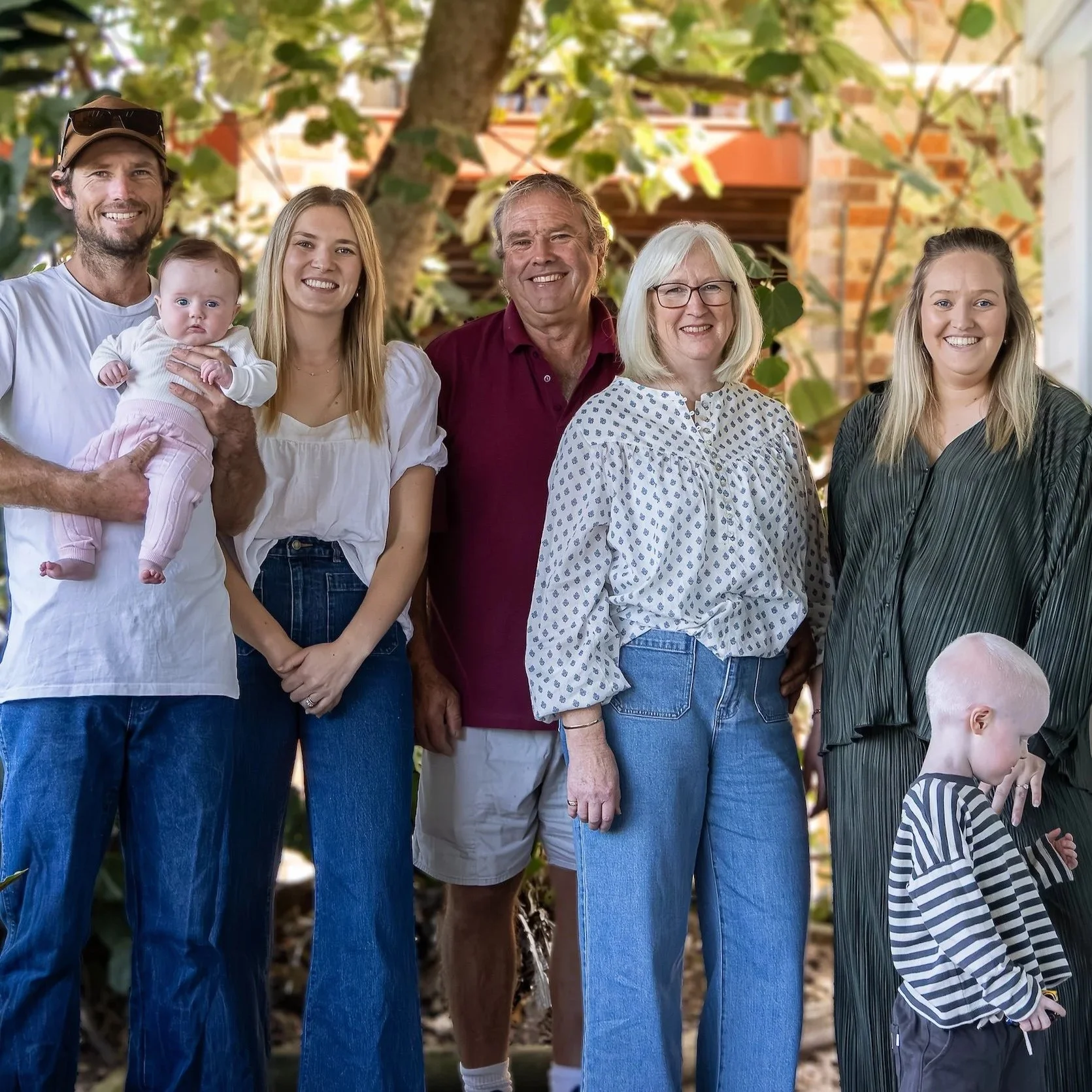 Three generations of family smiling together during a family photography session in Yass, NSW