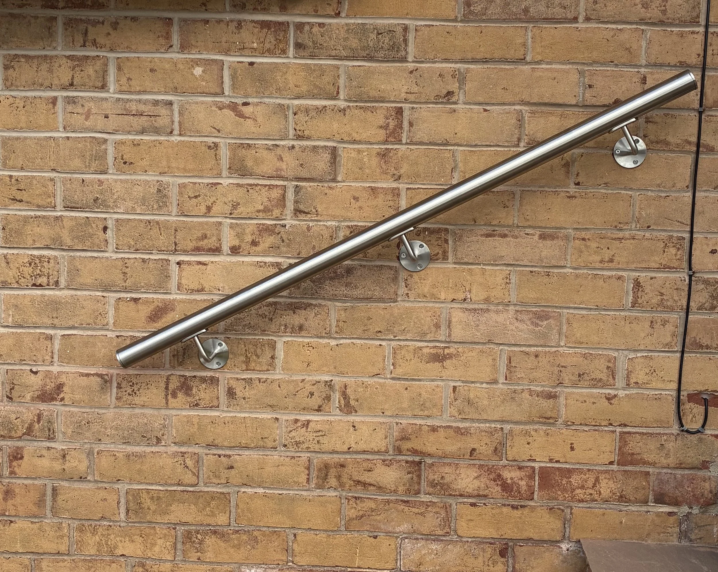 Bespoke 316 stainless steel handrail, designed, fabricated and installed by Sharland Steelworks. Featuring fully welded and polished joints for a seamless, high-quality finish. Made to measure for strength, durability and a modern appearance, ideal f