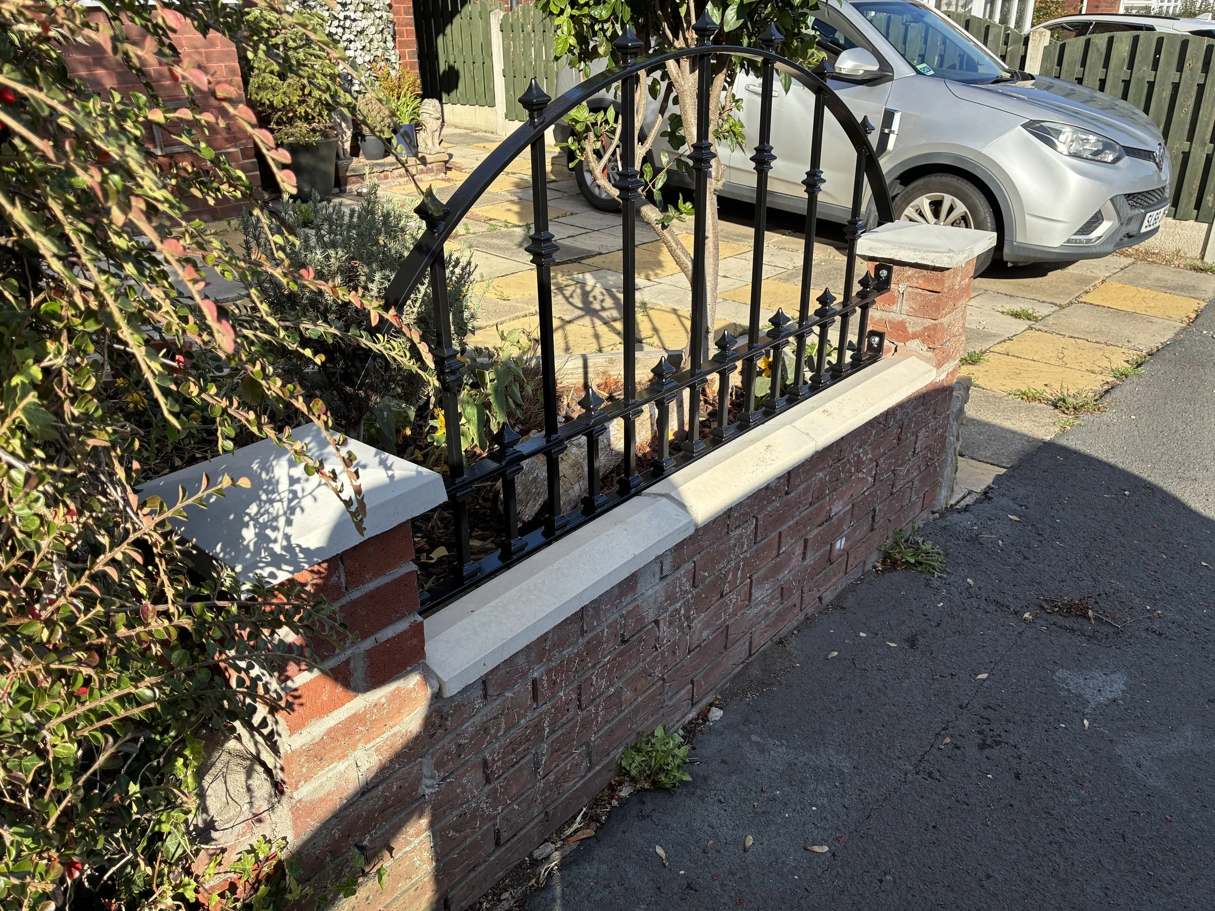 Bespoke Victorian-style wrought iron railings with an elegant arched top design, manufactured and installed by Sharland Steelworks in Wakefield, West Yorkshire. Traditional decorative steelwork combining heritage-inspired styling, quality craftsmansh