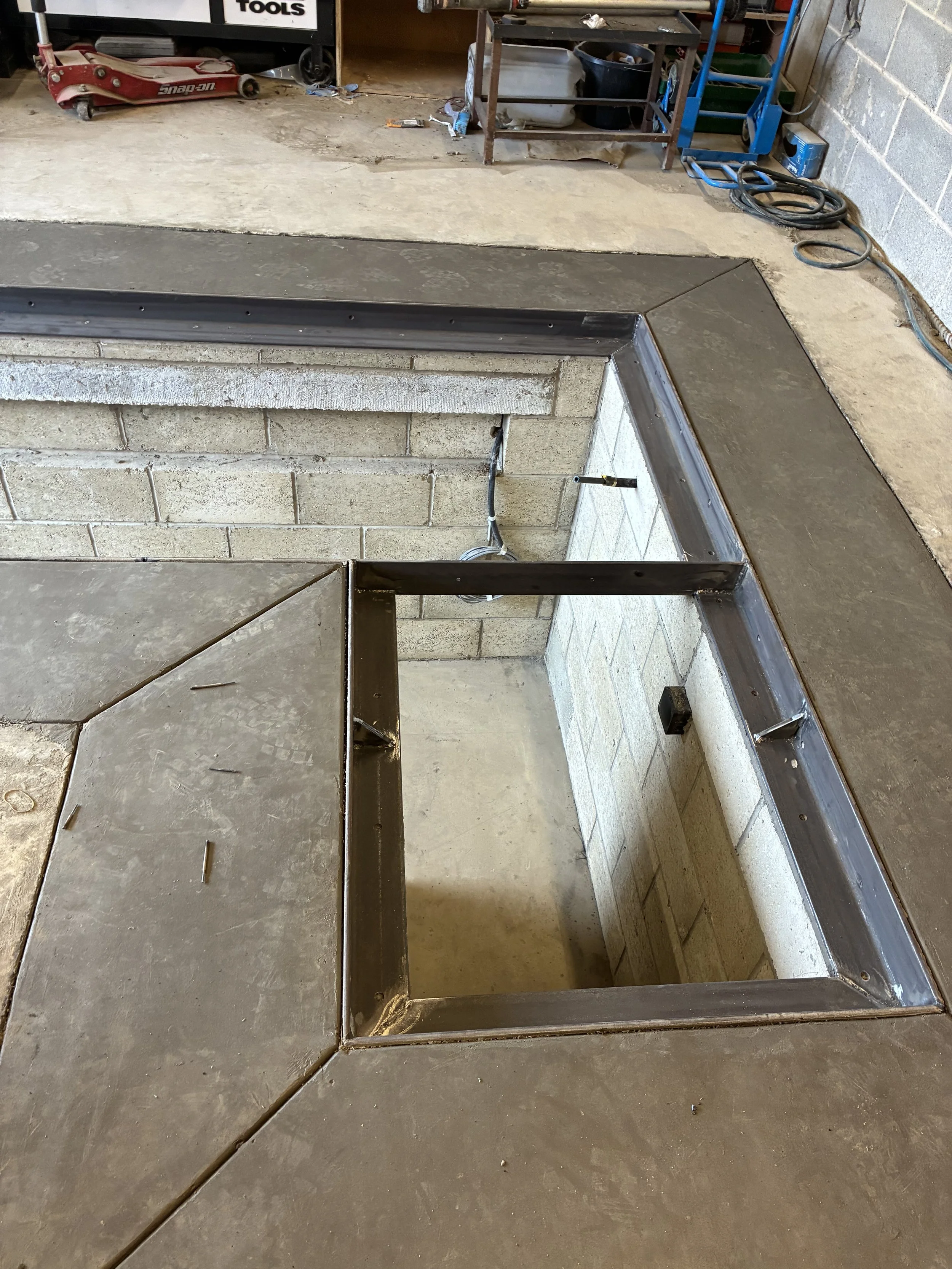 Mild steel angle iron frame around inspection pit to house cover boards. welded on site.