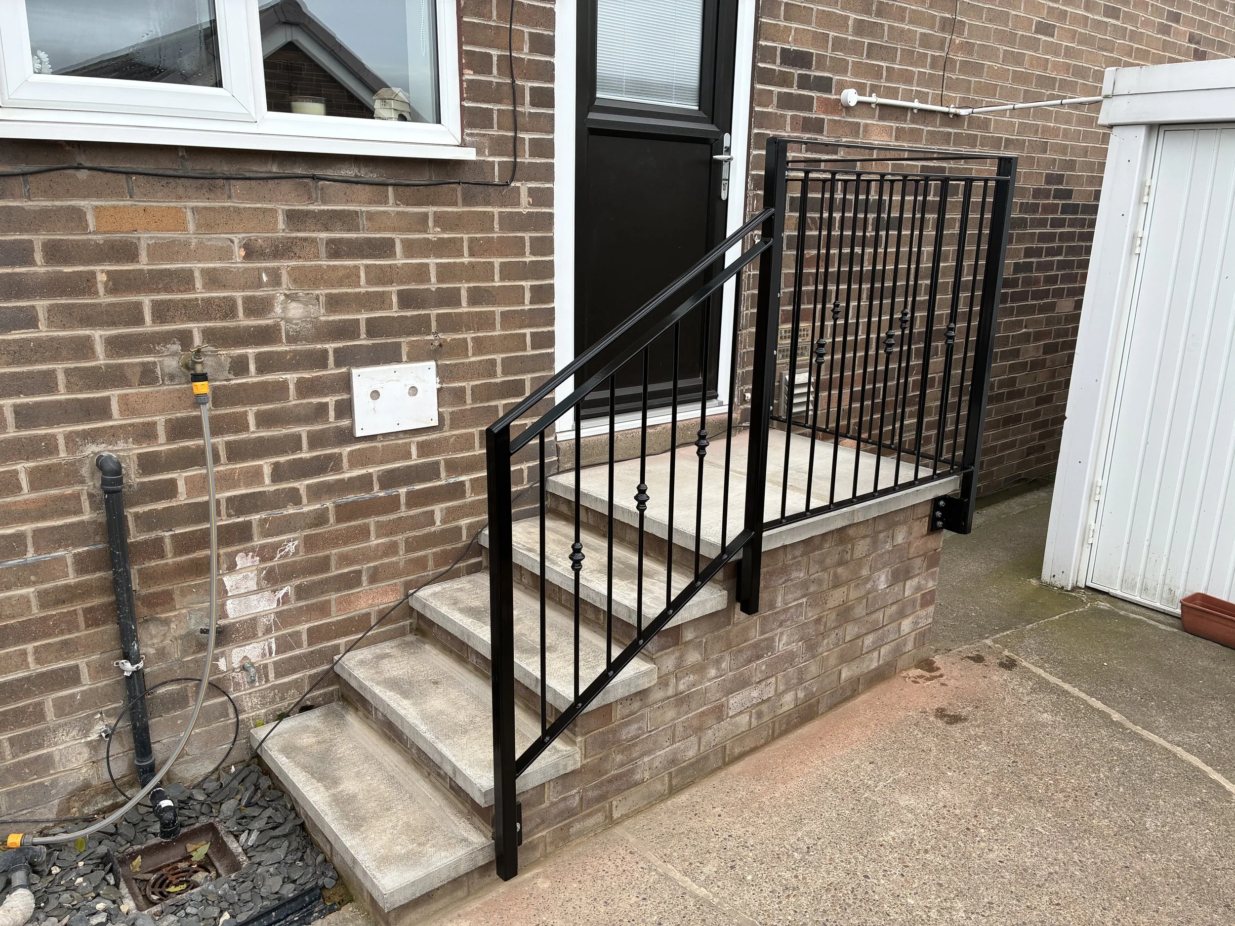Bespoke steel handrail, manufactured and installed by Sharland Steelworks in Mapplewell, Barnsley, South Yorkshire. Made to measure to provide safe, reliable support when using steps, combining practical functionality with quality craftsmanship and a