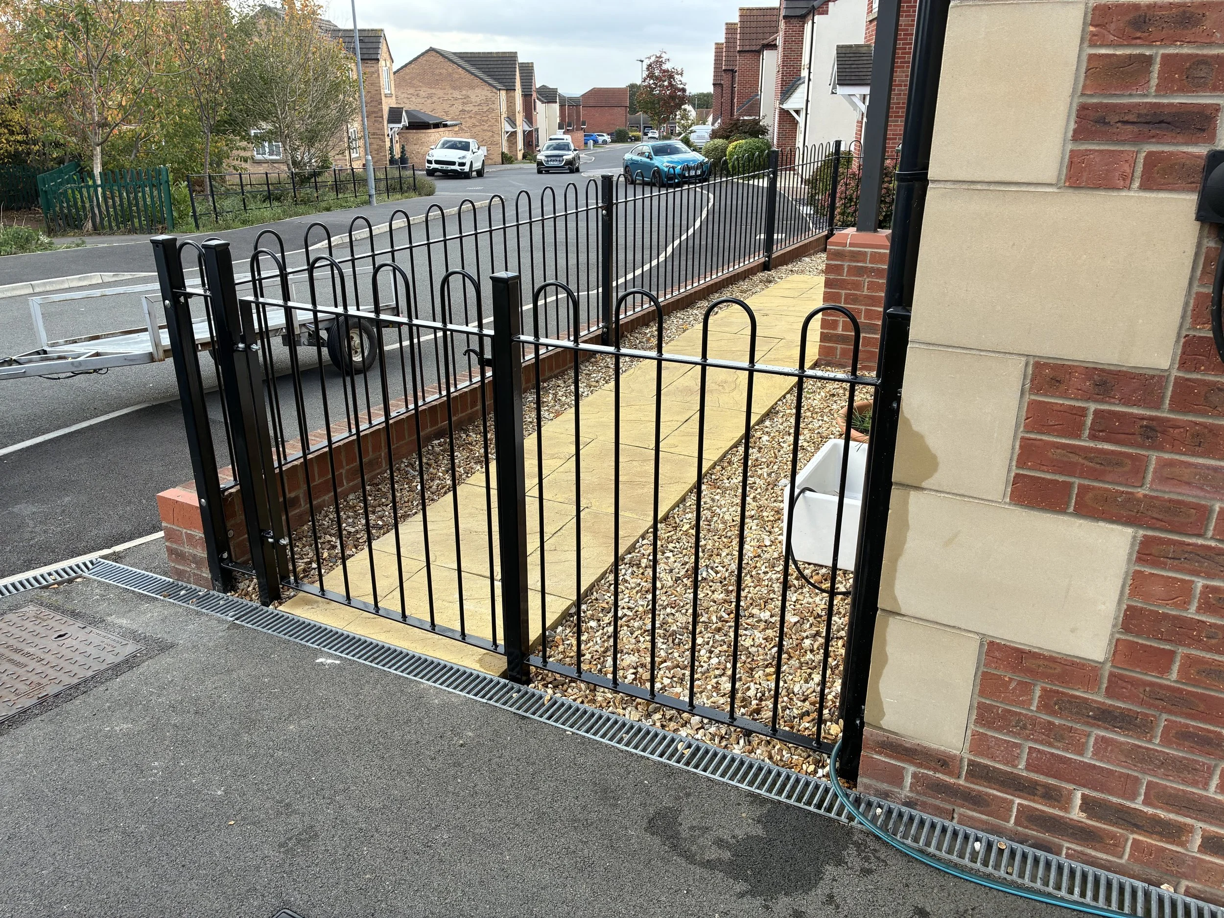 Bespoke hoop top wrought iron railings, manufactured and installed by Sharland Steelworks in Barnsley, South Yorkshire. Traditional curved steel railing design with a durable black finish, combining classic styling with quality craftsmanship.