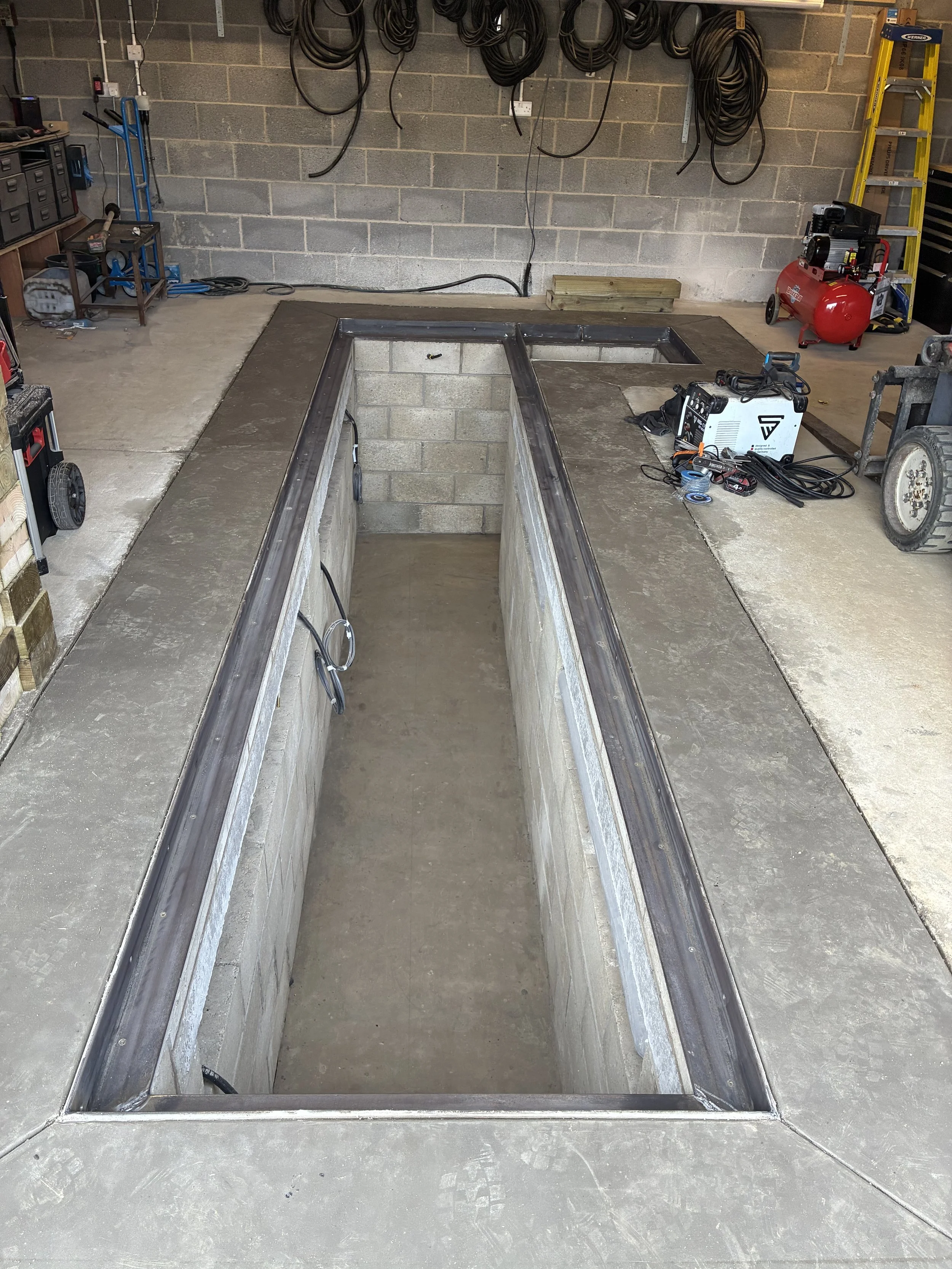 Mild steel angle iron frame around inspection pit to house cover boards. welded on site.